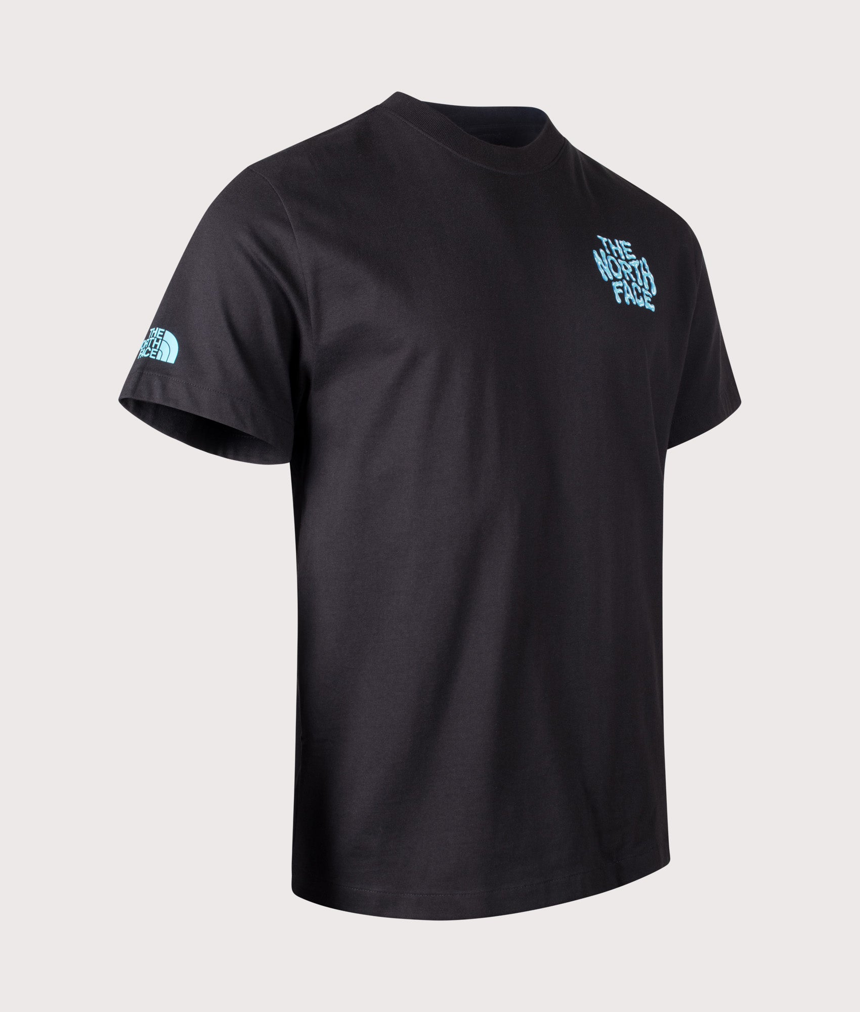 The North Face Relaxed Fit Drip Logo T-Shirt in TNF Black at EQVVS Menswear. Angled shot.
