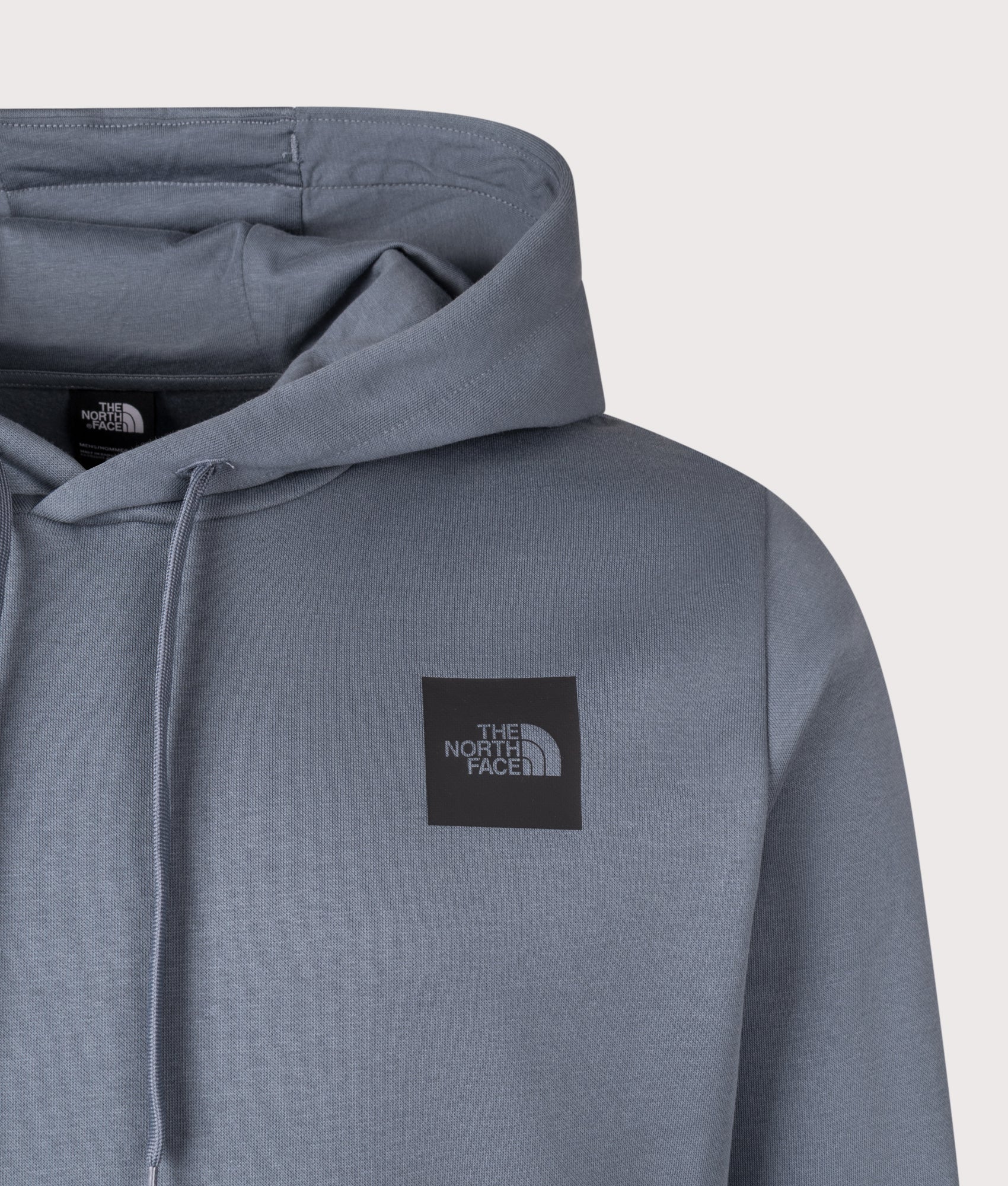 The North Face Evolution Box Hoodie in Granite Grey at EQVVS Menswear. Detail shot.