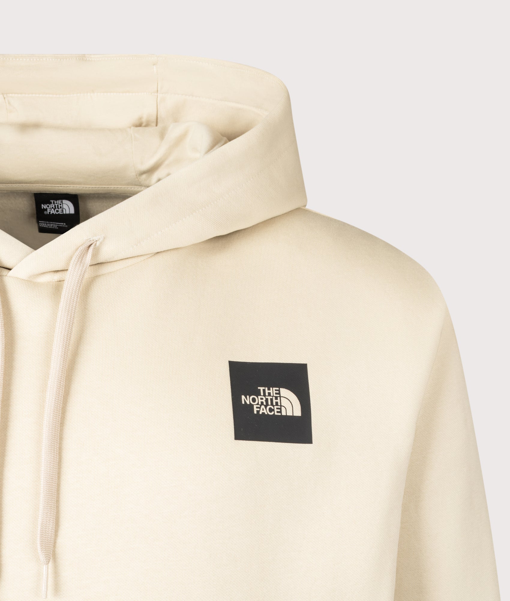 The North Face Evolution Box Hoodie in Desert Stone at EQVVS Menswear. Detail shot.