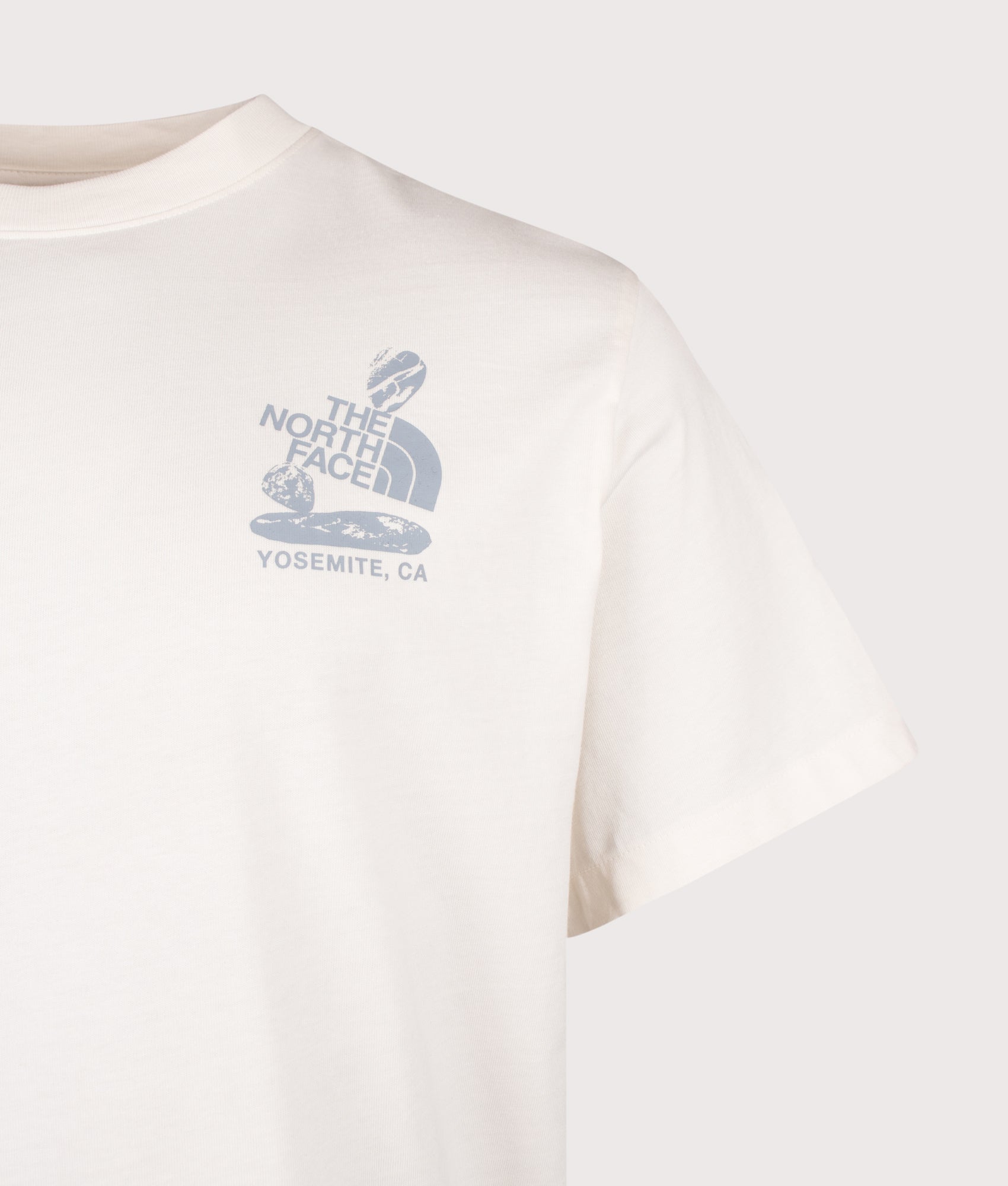 The North Face Relaxed Fit Stones Graphic T-Shirt in White Dune at EQVVS Menswear. Detail shot.