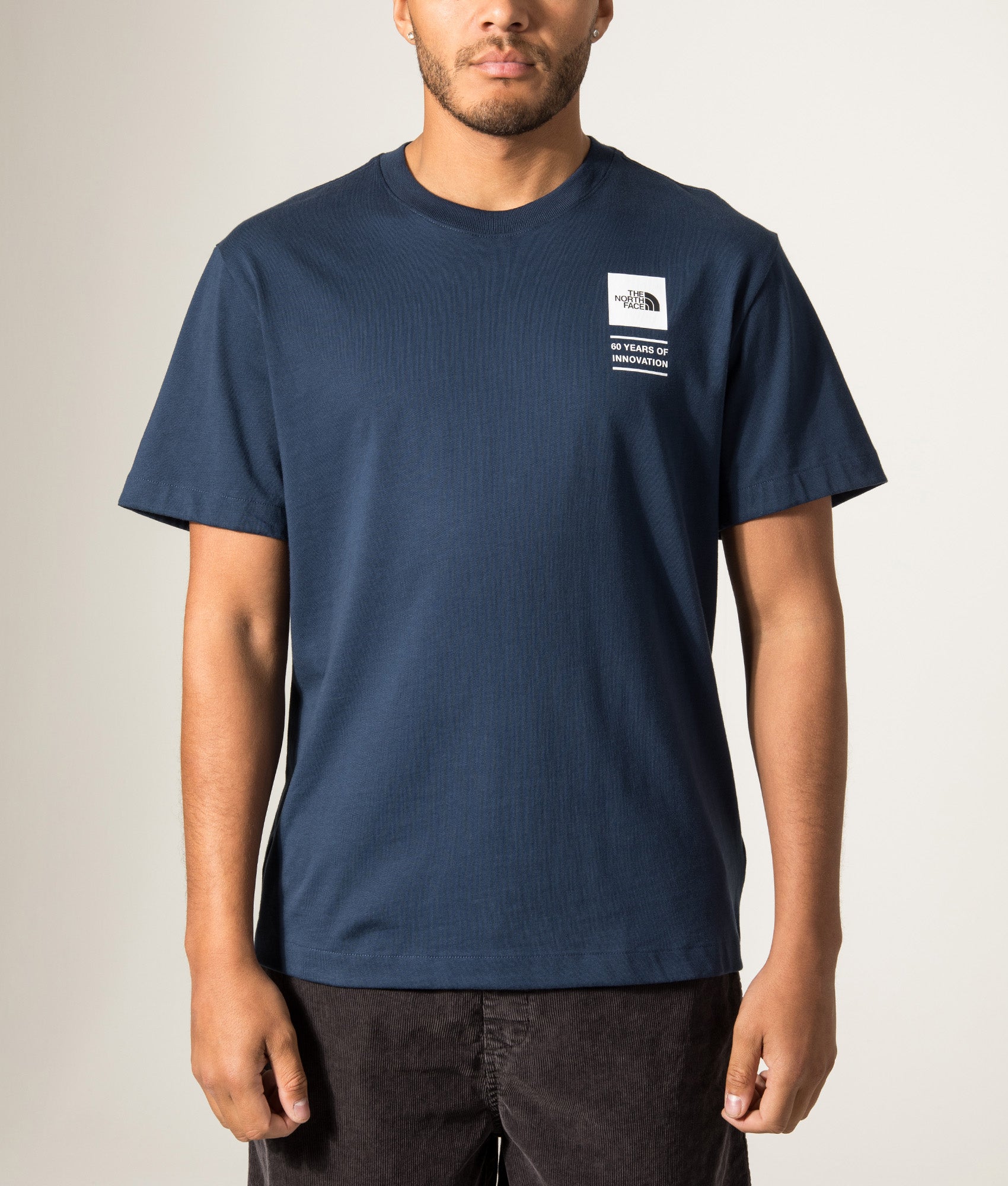The North Face Relaxed Fit Celebration TNF T-Shirt in Summit Navy at EQVVS Menswear. Model front shot.