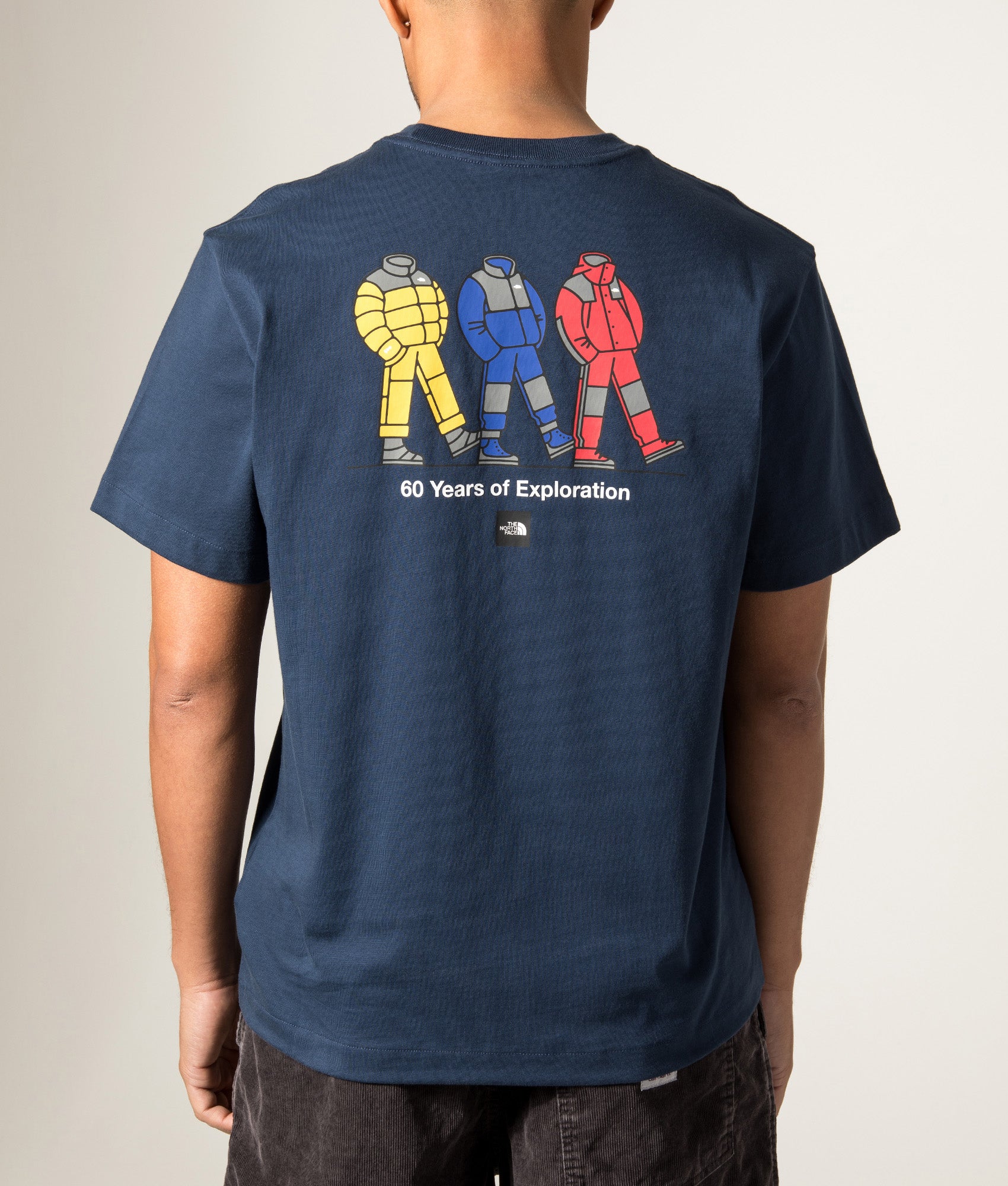 The North Face Relaxed Fit Celebration TNF T-Shirt in Summit Navy at EQVVS Menswear. Model back shot.