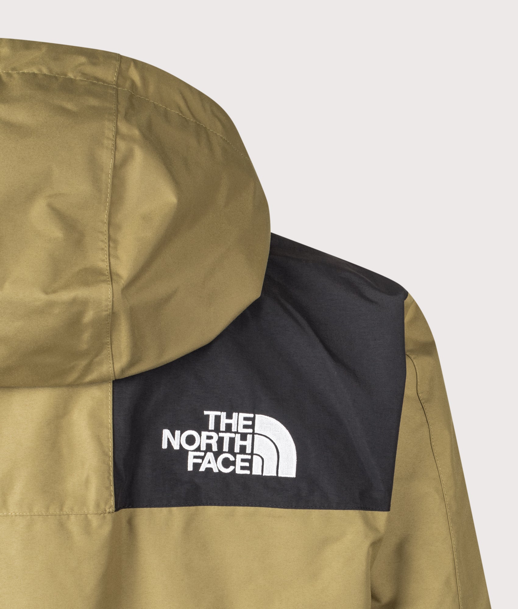 The North Face Relaxed Fit Reign On Jacket in Cedar and TNF Black at EQVVS Menswear. Back detail shot.