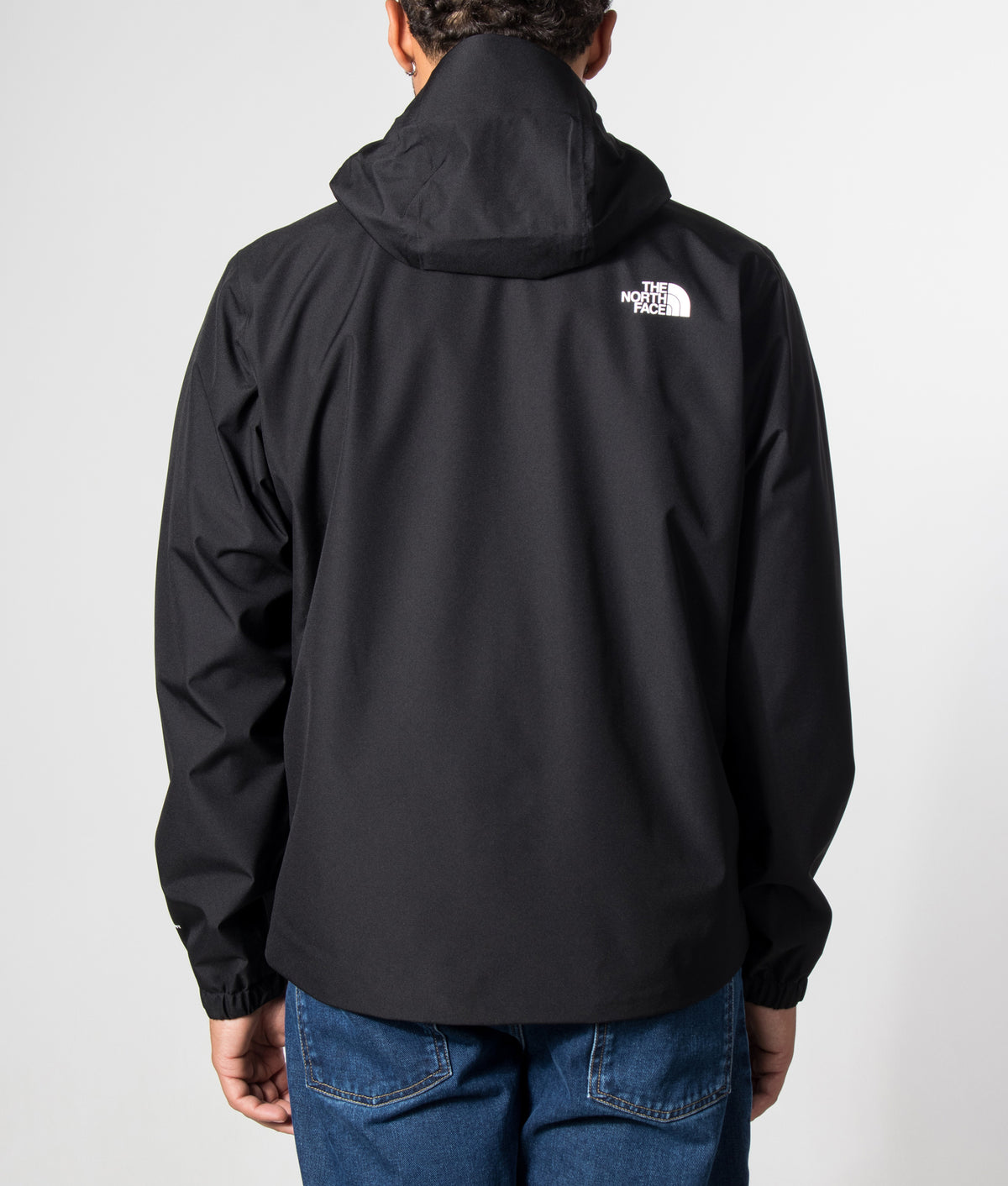 The North Face Regular Fit Quest DryVent™ Jacket in TNF Black at EQVVS Menswear. Model back shot.