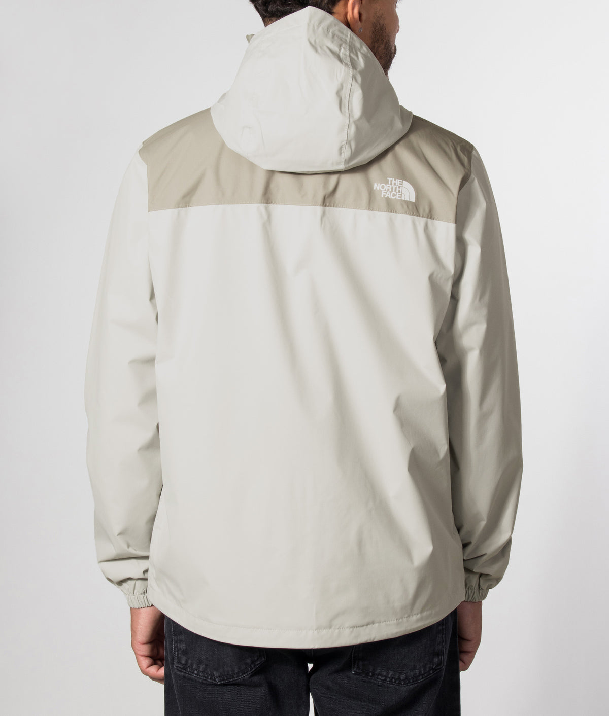 The North Face Regular Fit Antora Jacket in Cumulus Cloud and Stone Slab at EQVVS Menswear. Model back shot.