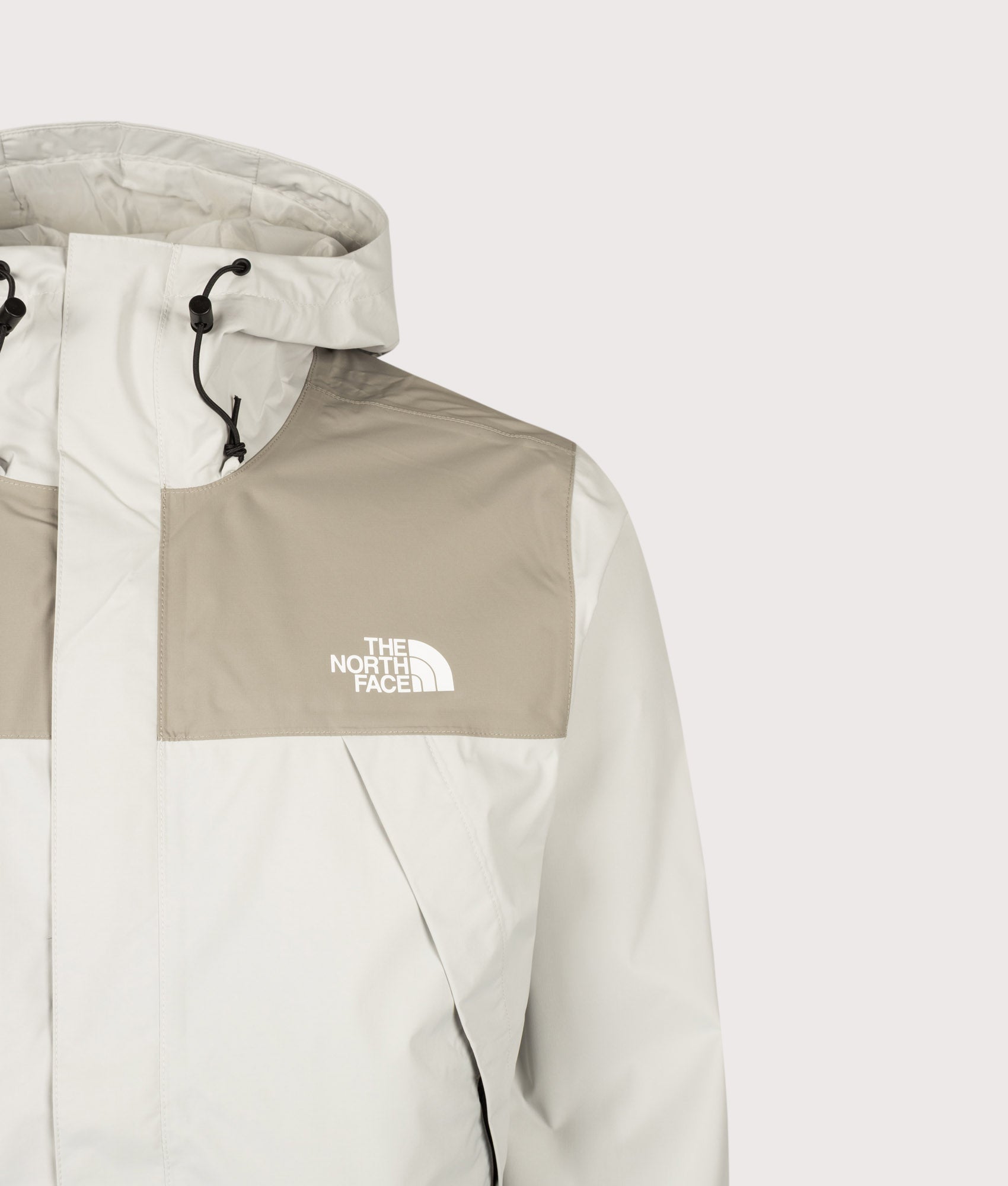 The North Face Regular Fit Antora Jacket in Cumulus Cloud and Stone Slab at EQVVS Menswear. Front detail shot.
