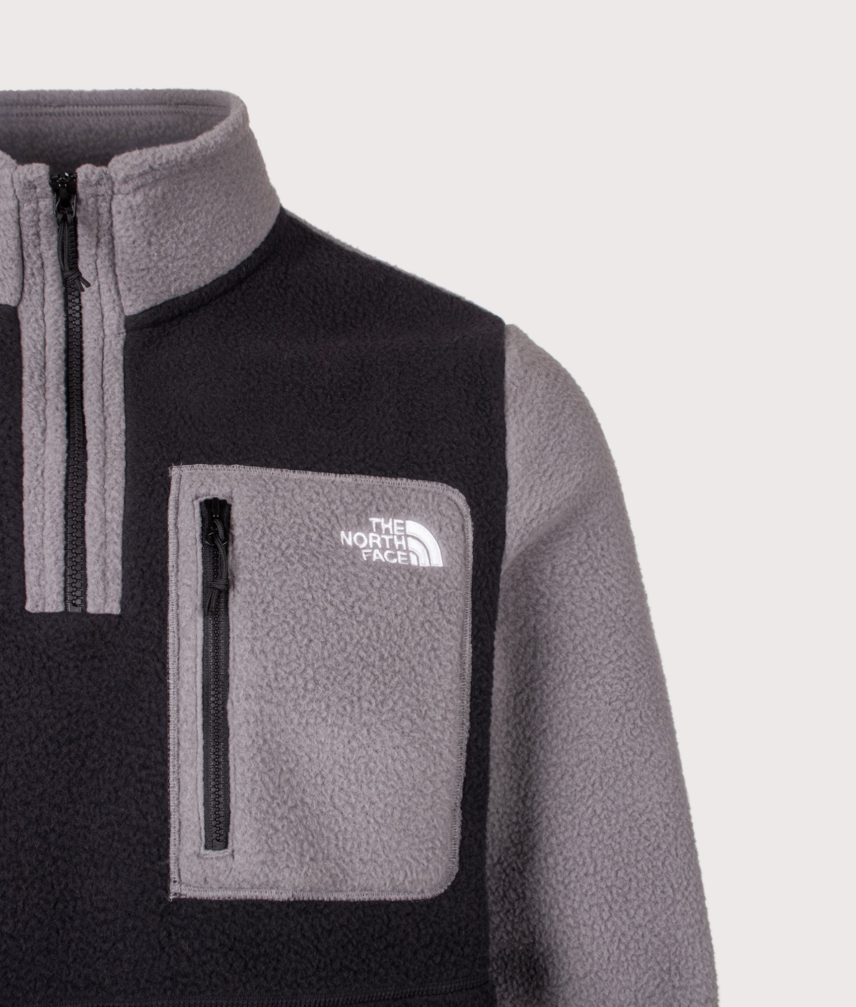 The North Face Regular Fit Yumiori Quarter Zip Fleece in Smoked Pearl and TNF Black at EQVVS Menswear. Detail shot.