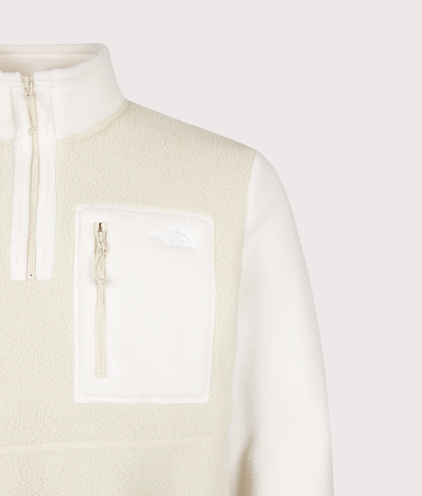 The North Face Regular Fit Yumiori Quarter Zip Fleece in Desert Stone and White at EQVVS Menswear. Detail shot.