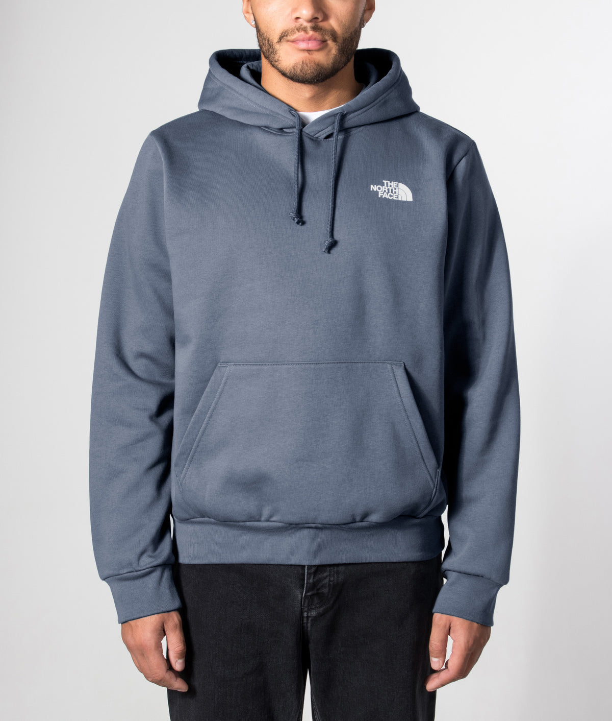 The North Face Regular Fit NSE Evolution Box Hoodie in Granite Grey at EQVVS Menswear. Model front shot.