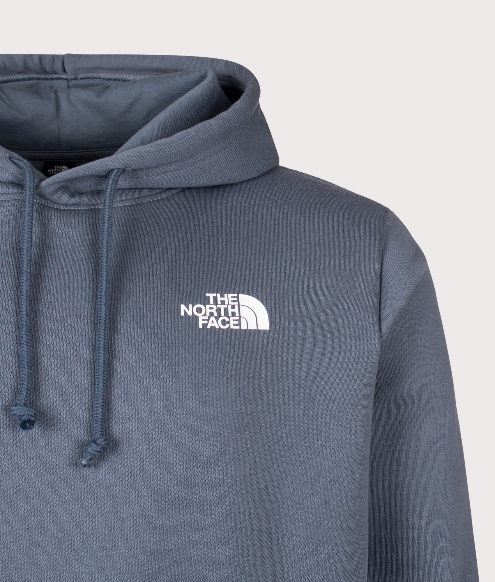The North Face Regular Fit NSE Evolution Box Hoodie in Granite Grey at EQVVS Menswear. Detail shot.