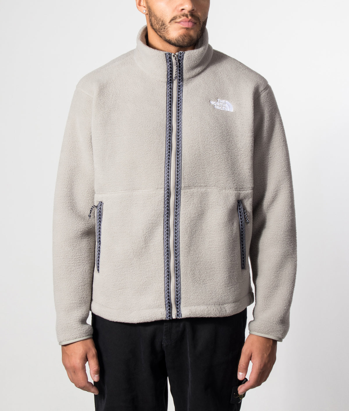 The North Face Relaxed Fit TNF Fleeski Zip Through Fleece in Stone Slab at EQVVS Menswear. Model front shot.