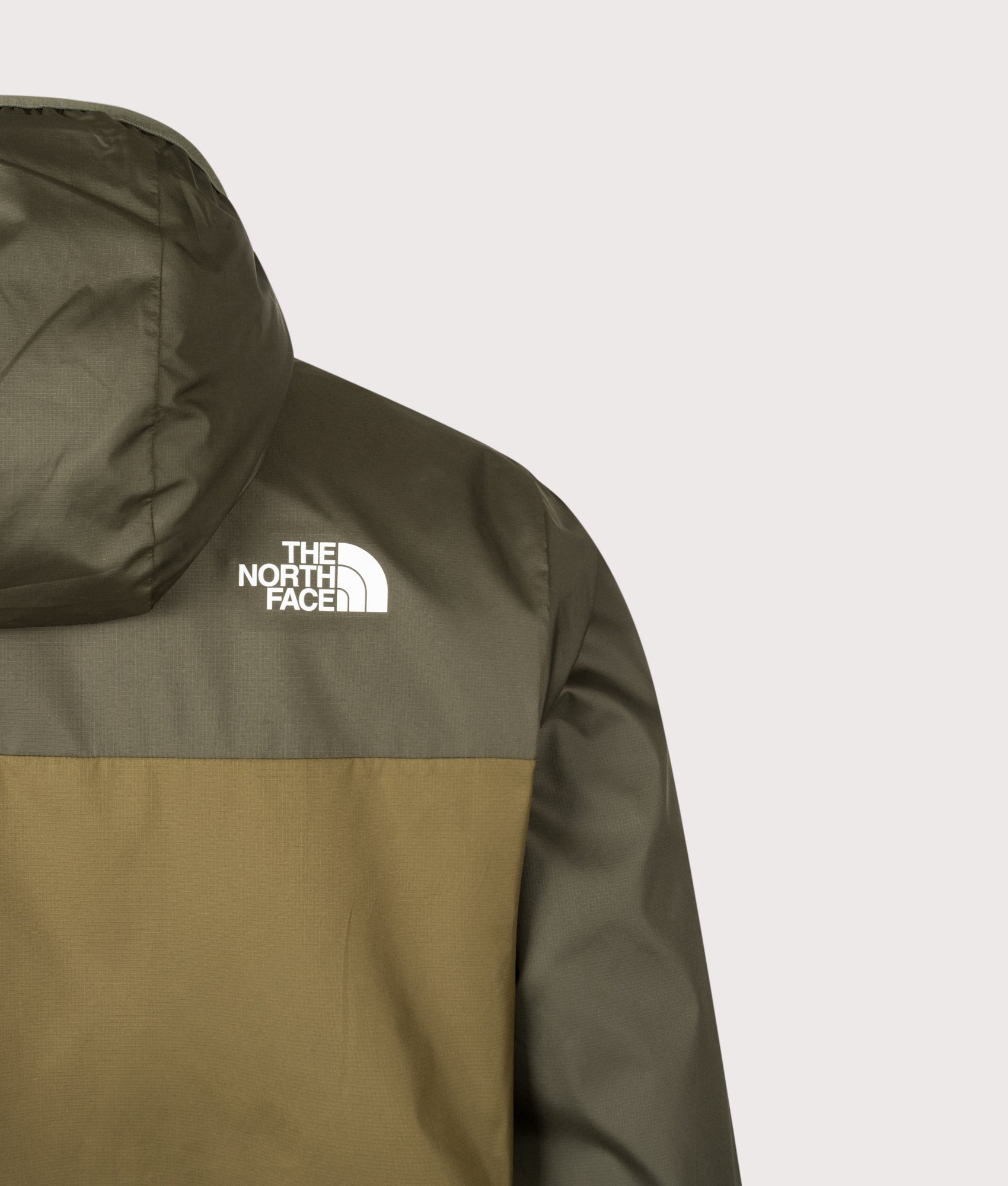 The North Face Regular Fit Nuketo Windbreaker in Caraway Seed and New Taupe Green at EQVVS Menswear. Back detail shot.