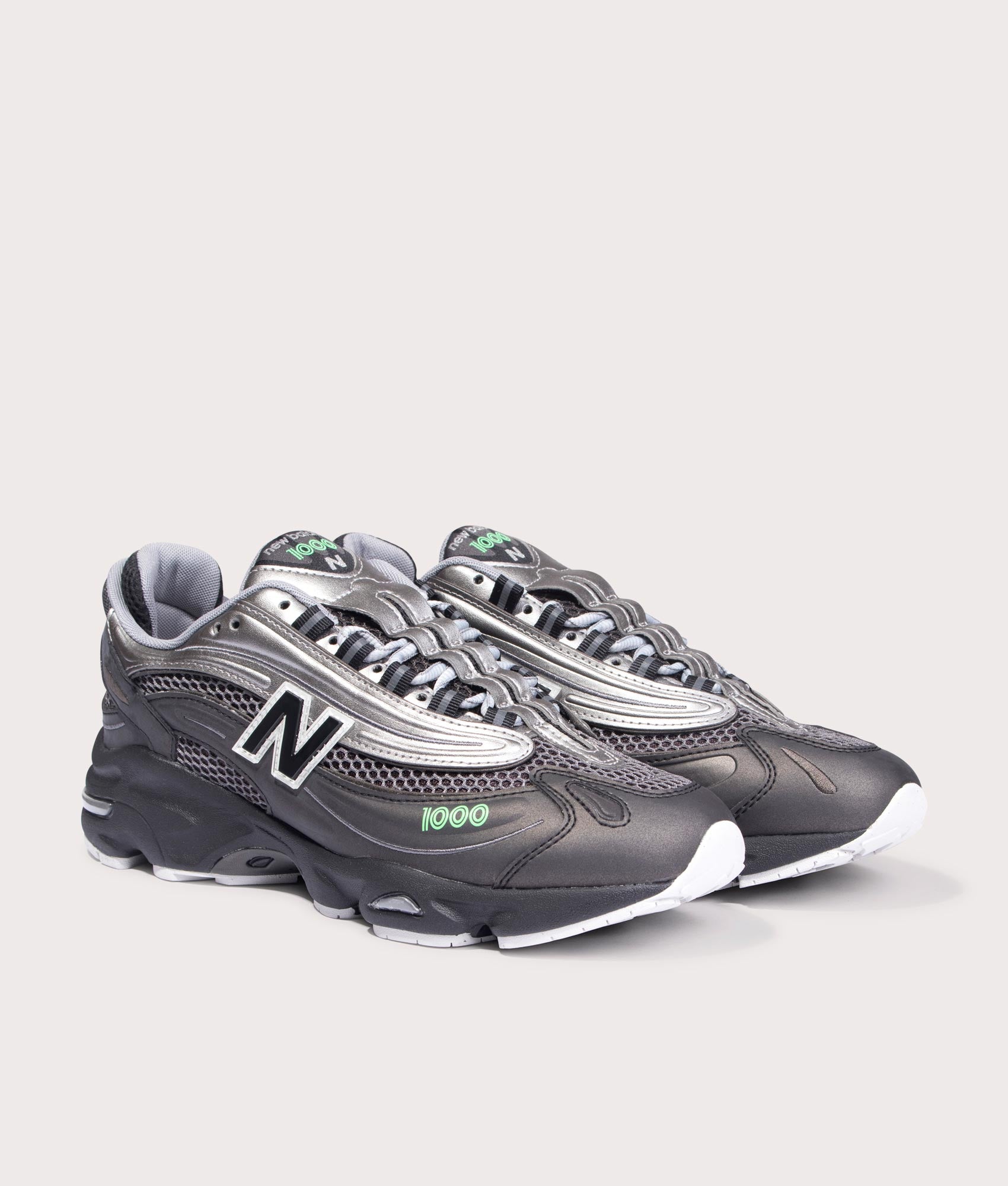 New Balance 1000 Sneakers in Black, Dark Silver Metallic and Lime Leaf at EQVVS Menswear. Angled front shot.