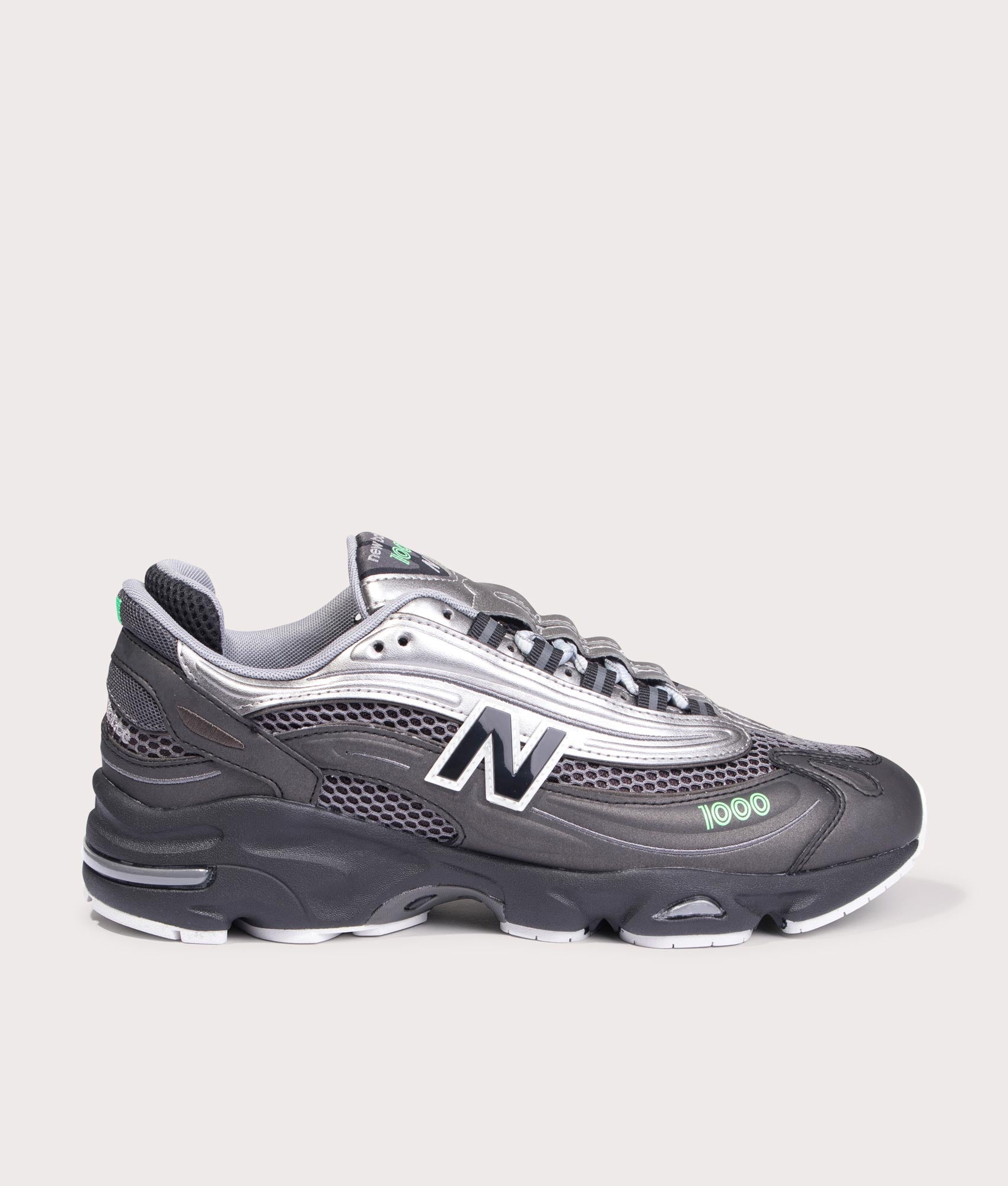 New Balance 1000 Sneakers in Black, Dark Silver Metallic and Lime Leaf at EQVVS Menswear. Side shot.