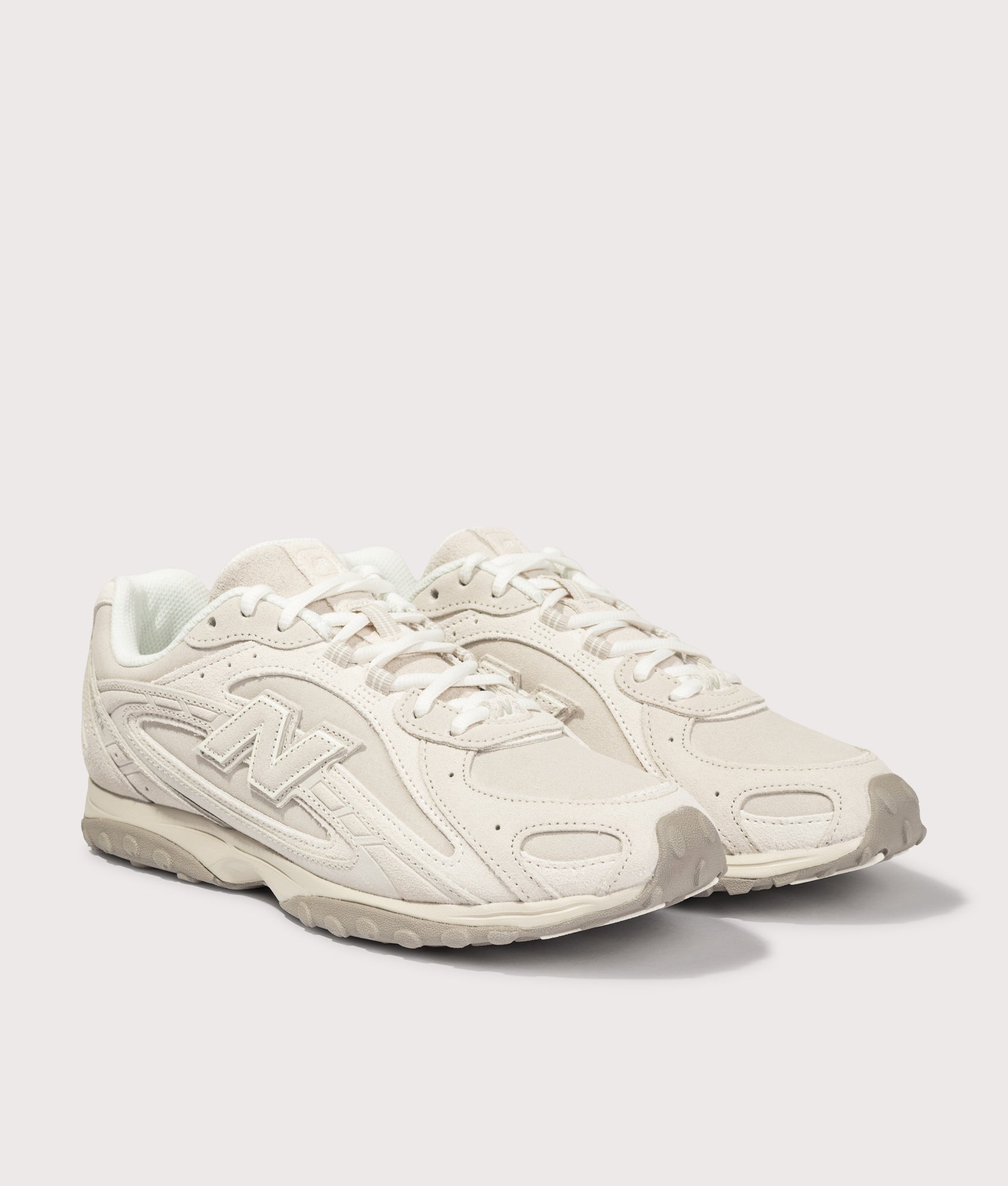 New Balance 204L Sneakers in Timberwolf and Linen at EQVVS Menswear. Angled front shot.
