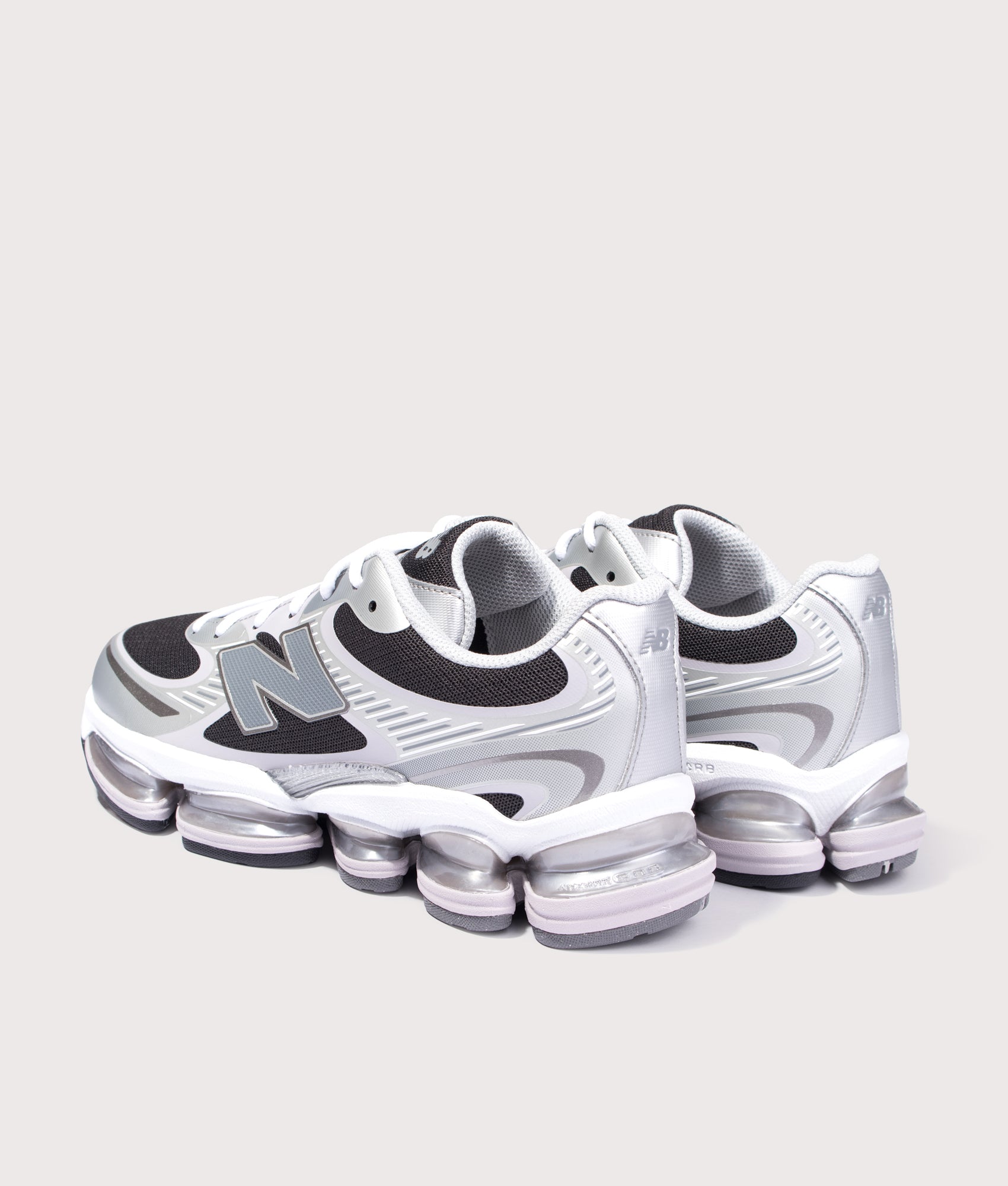 New Balance ABZORB 2000 Sneakers in Silver Metallic and Faded Black at EQVVS Menswear. Angled back shot.