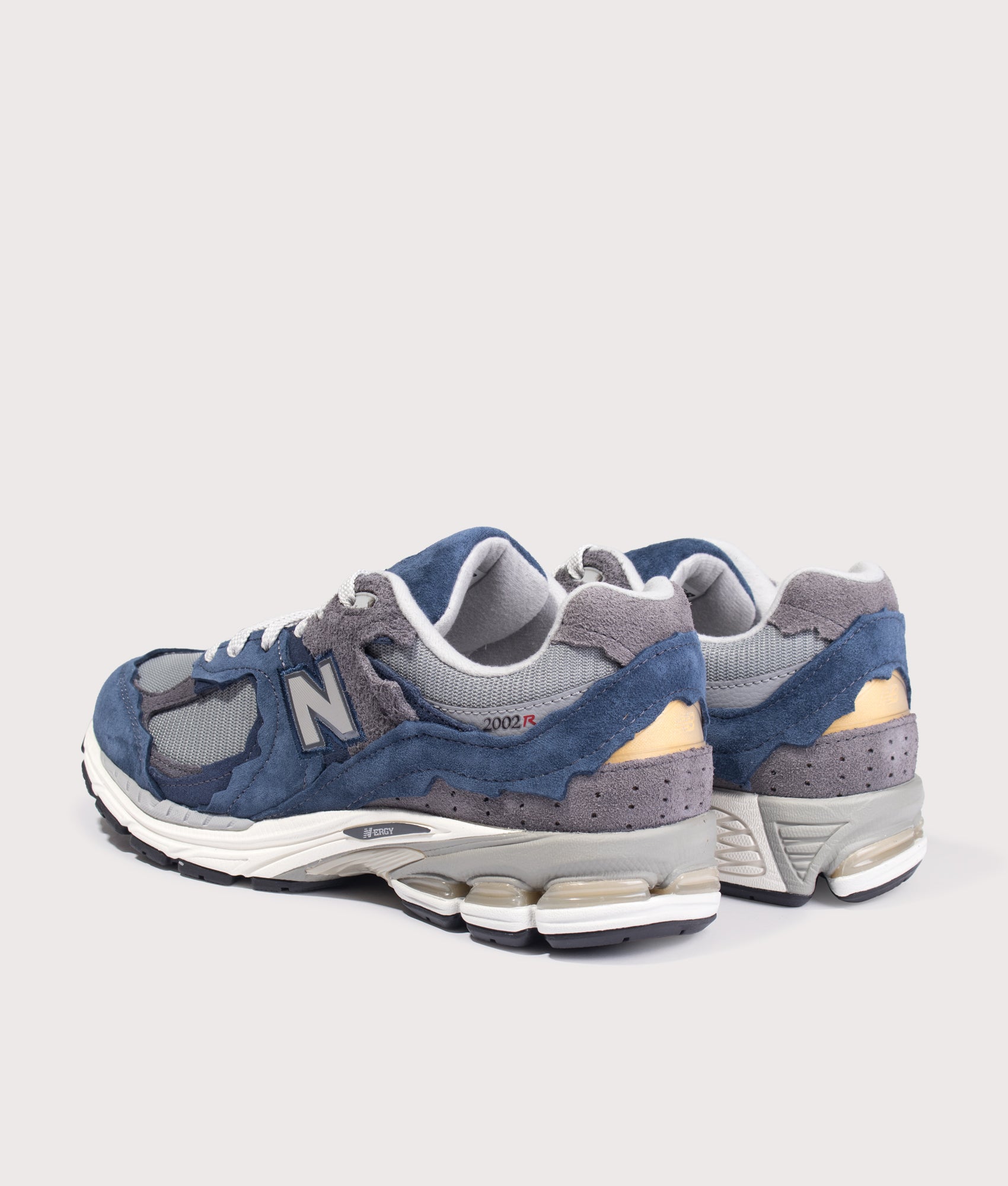 New Balance 2002D Protection Pack Sneakers in NB Navy at EQVVS Menswear. Angled back shot.