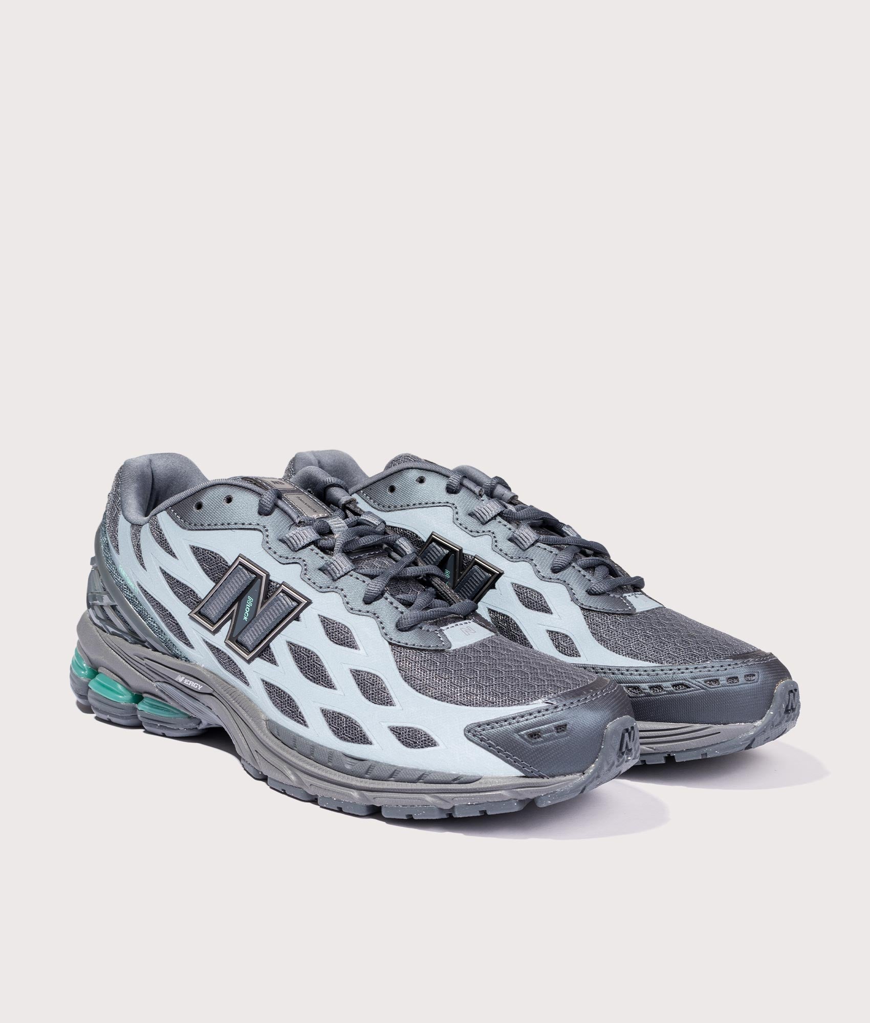 New Balance 1906WV1 Reflective Sneakers in Graphite at EQVVS Menswear. Reflective angled front shot.
