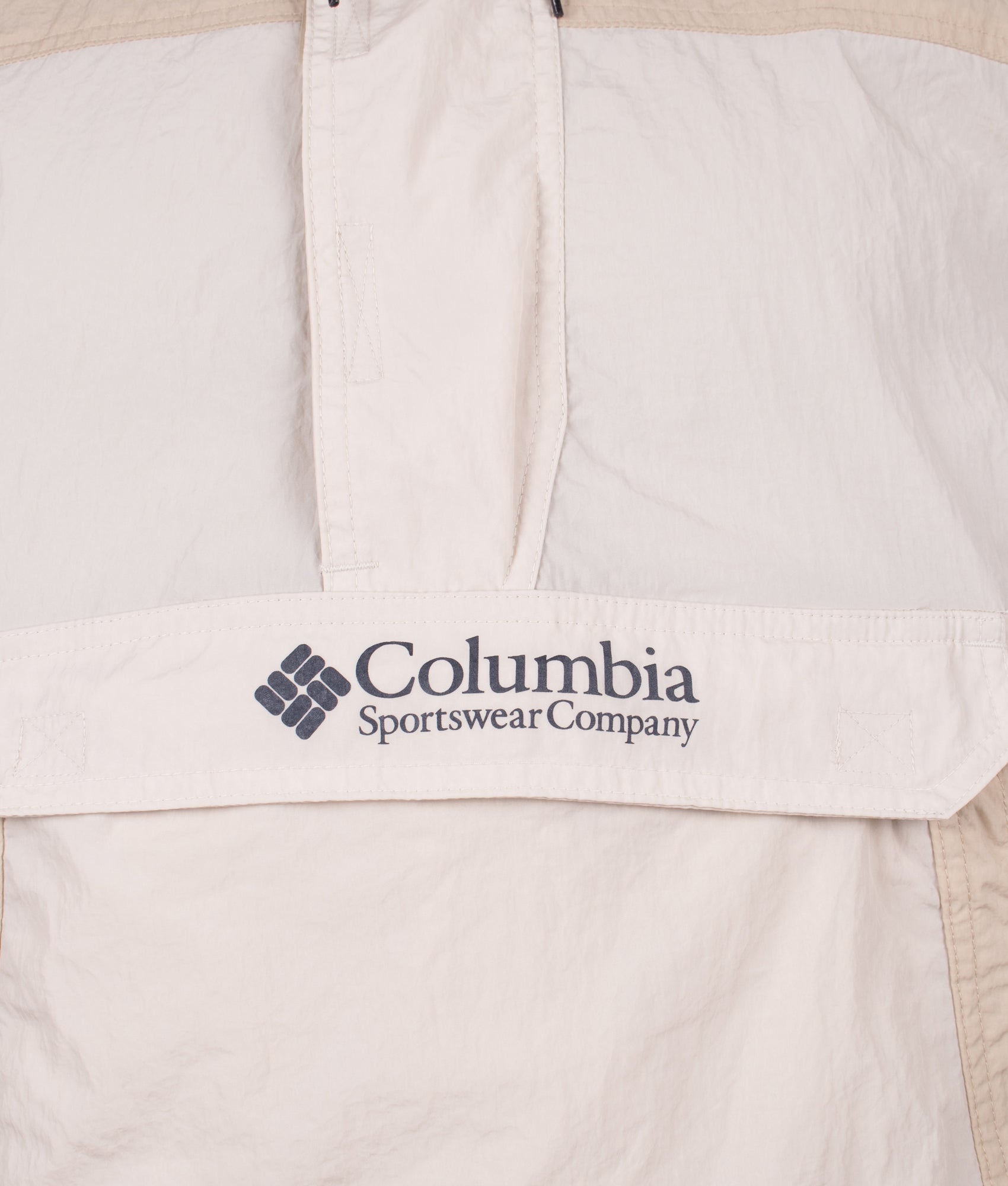 Columbia Challenger Windbreaker Anorak in Dark Stone and Ancient Fossil at EQVVS Menswear. Detail shot.