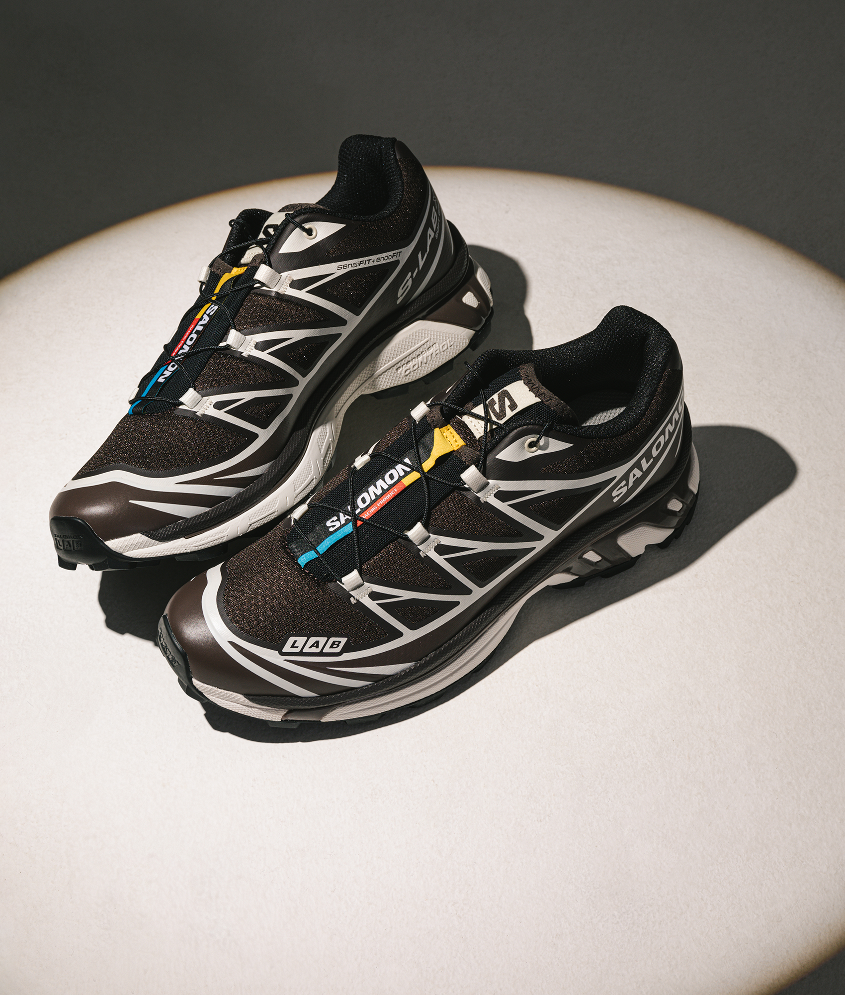 SALOMON XT-6 GTX Sneakers in Black Coffee/French Roast/Vanilla Ice at EQVVS Menswear. Campaign shot.