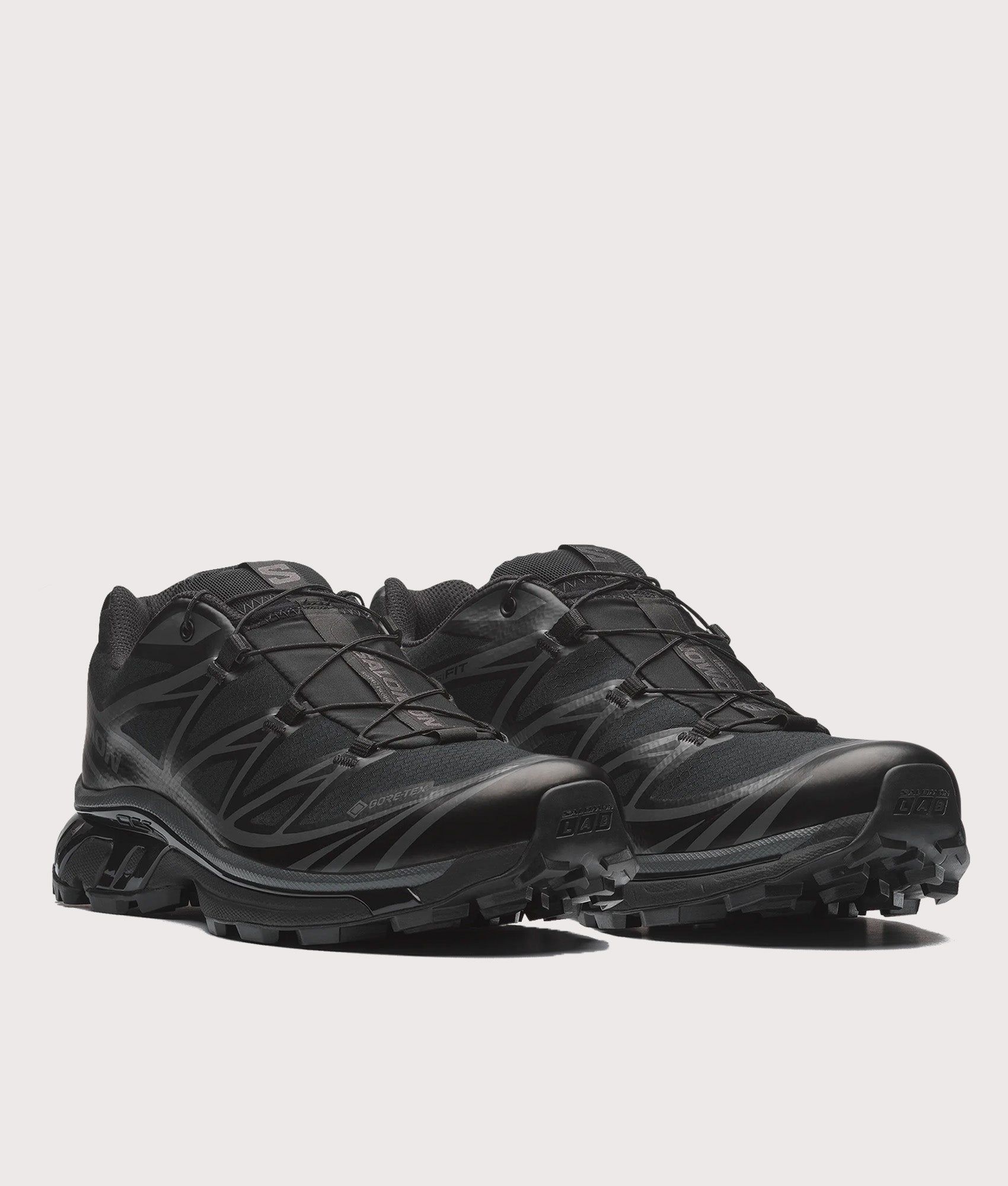 SALOMON XT-6 GTX Sneakers in Black and Asphalt at EQVVS Menswear. Angled front shot.