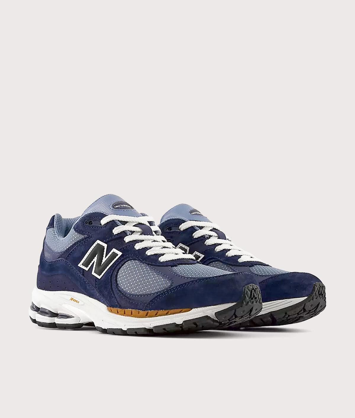 New Balance 2002R Sneakers in Navy and Vintage Indigo at EQVVS Menswear. Angled front shot.