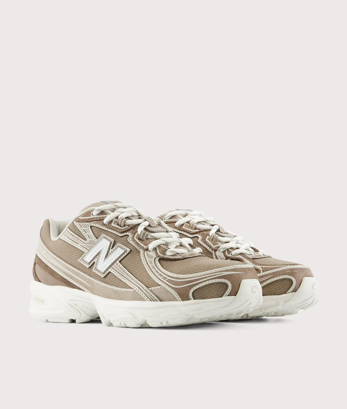 New Balance 740 Sneakers in Mushroom and Driftwood at EQVVS Menswear. Angled front shot.