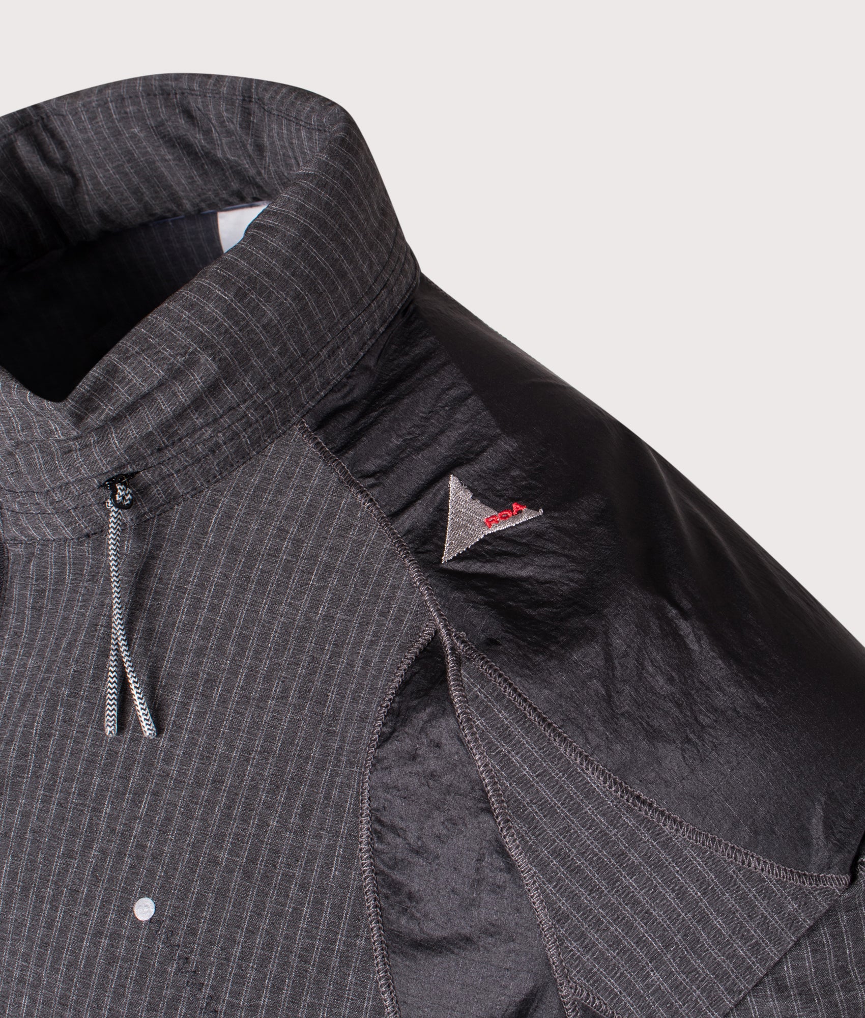ROA Numb Pinstriped Hooded Wind Jacket in Black at EQVVS Menswear.  Detail shot.