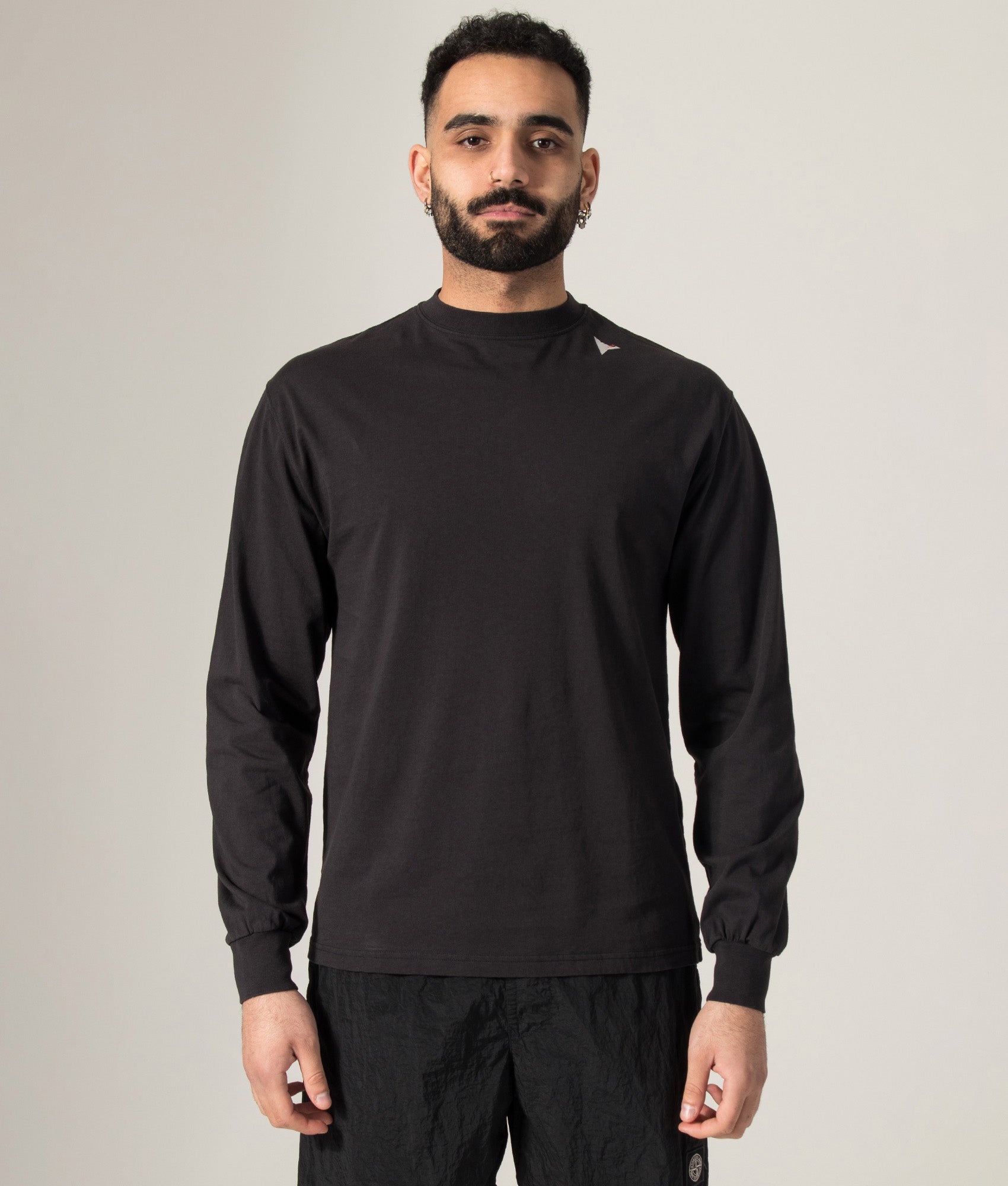 ROA Logo Long Sleeve T-Shirt in Washed Black at EQVVS Menswear. Model shot.