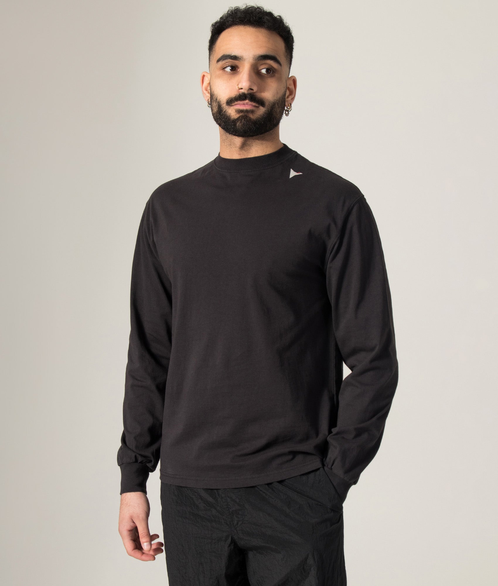 ROA Logo Long Sleeve T-Shirt in Washed Black at EQVVS Menswear. Model shot.