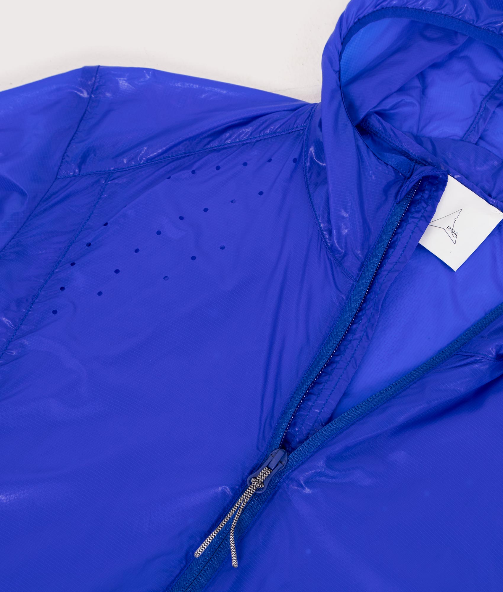 ROA Hue Packable Lightweight Windcheater in Blue at EQVVS Menswear. Detail shot.