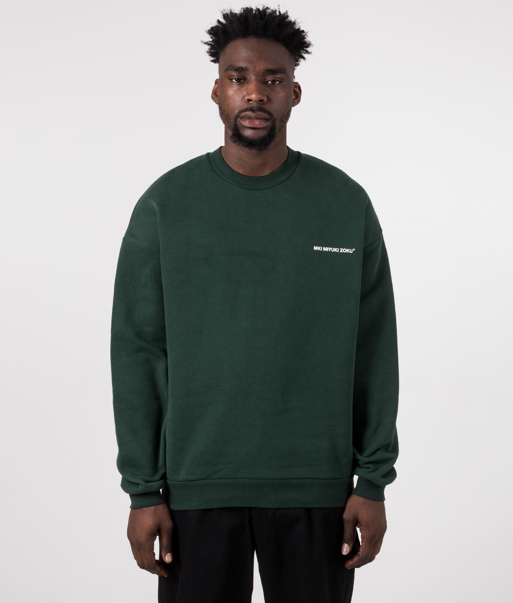 MKI MIYUKI ZOKU Oversized Uniform Crewneck Sweatshirt in Green at EQVVS Menswear. Model front shot.