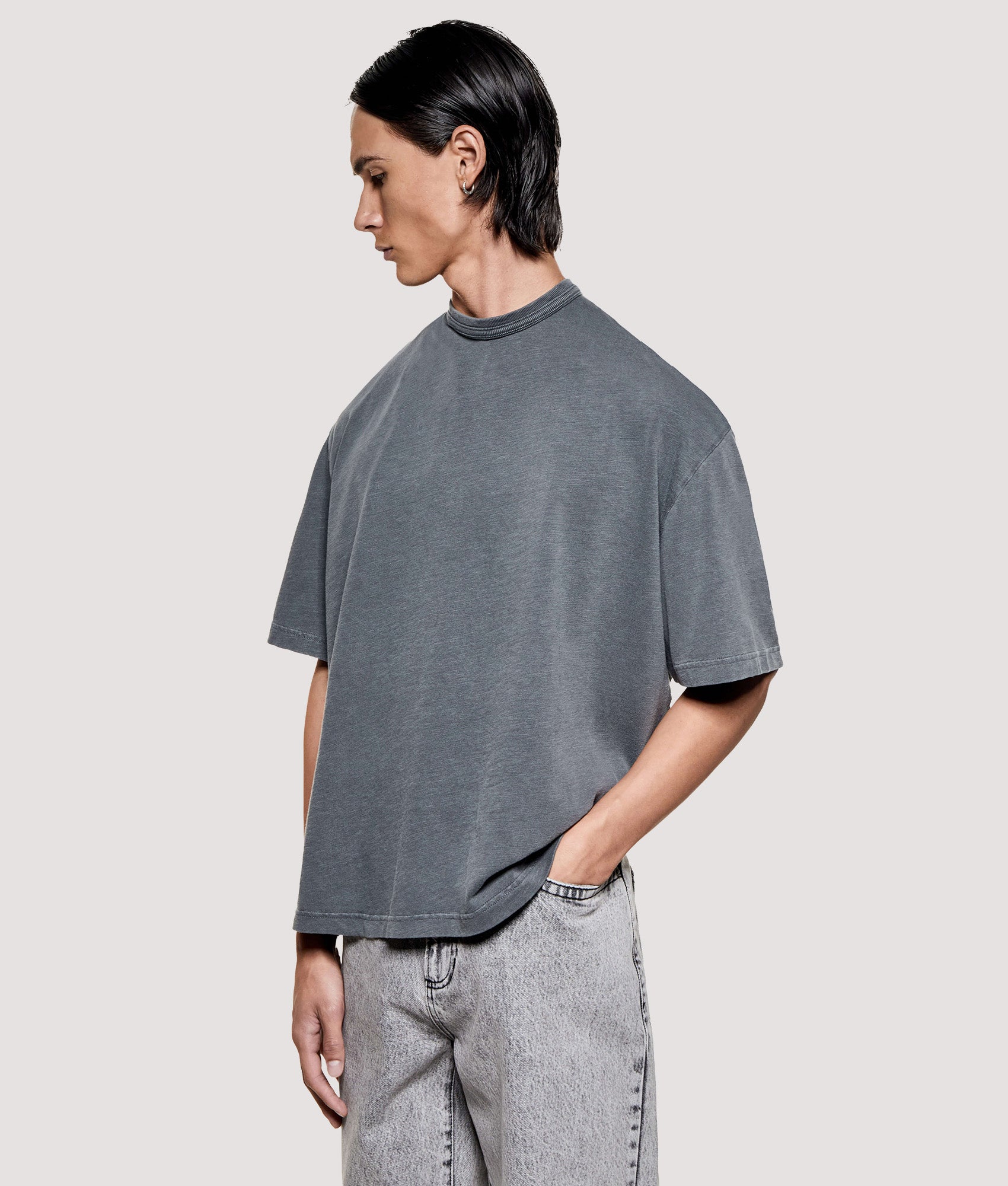 MKI MIYUKI ZOKU Box Fit 220 GSM Slub T-Shirt in Pigment Black at EQVVS Menswear. Angled model front shot.