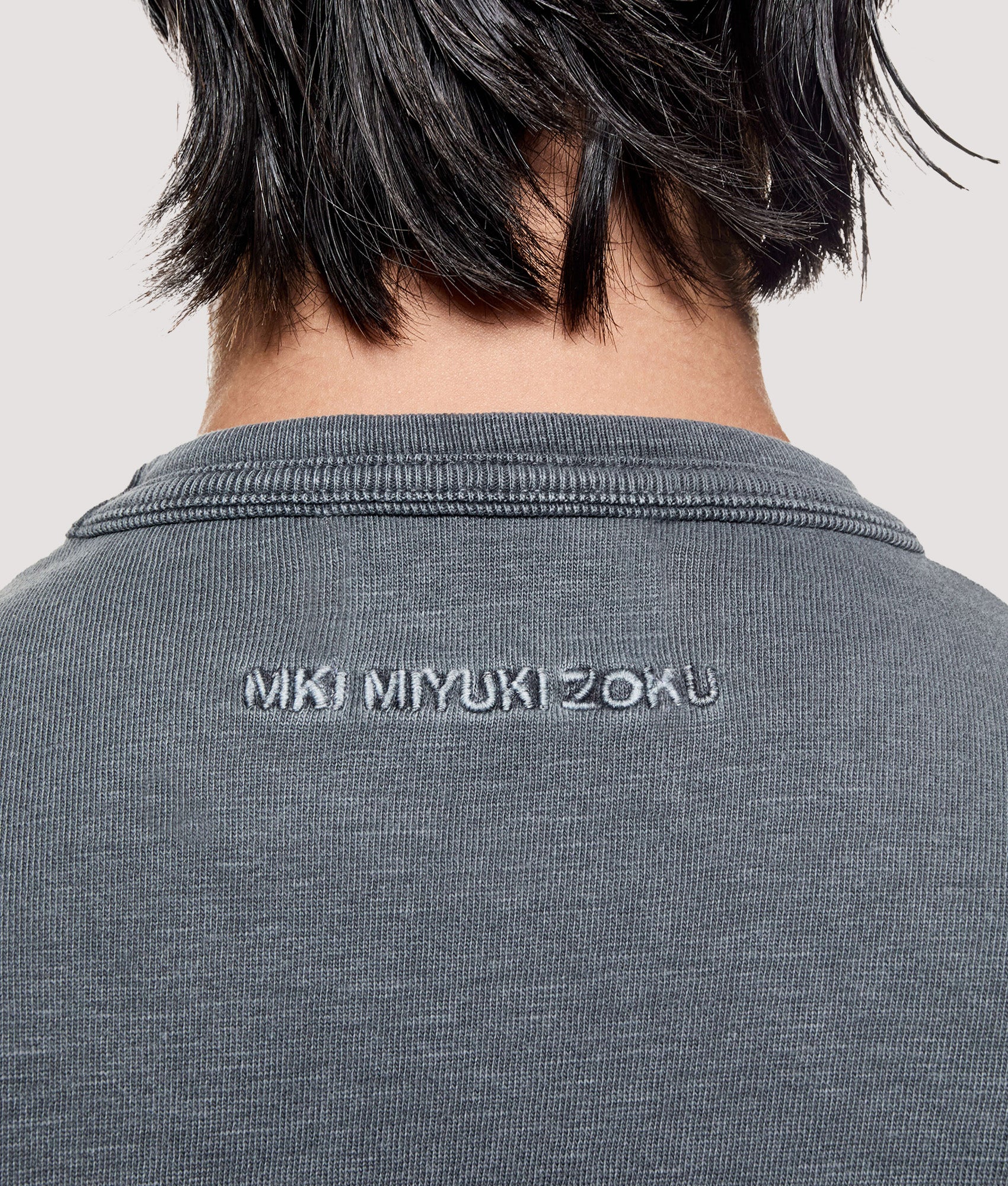 MKI MIYUKI ZOKU Box Fit 220 GSM Slub T-Shirt in Pigment Black at EQVVS Menswear. Detail shot.