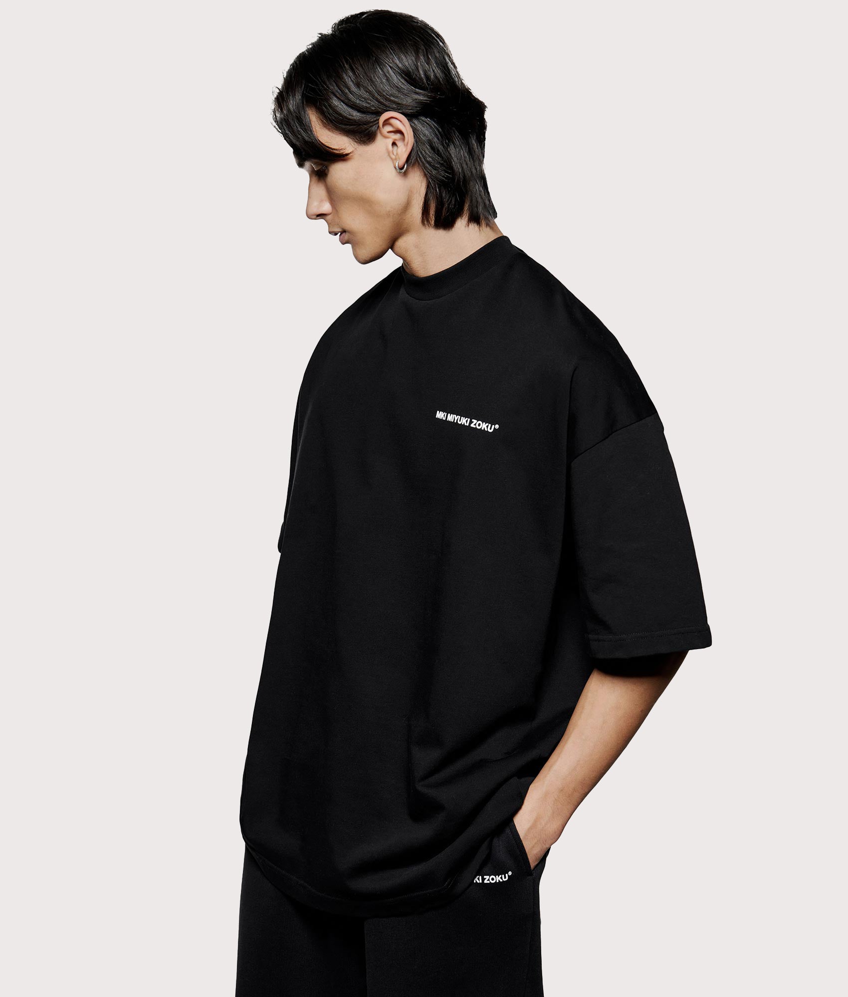 MKI MIYUKI ZOKU Oversized Uniform T-Shirt at EQVVS Menswear. Angled model front shot.