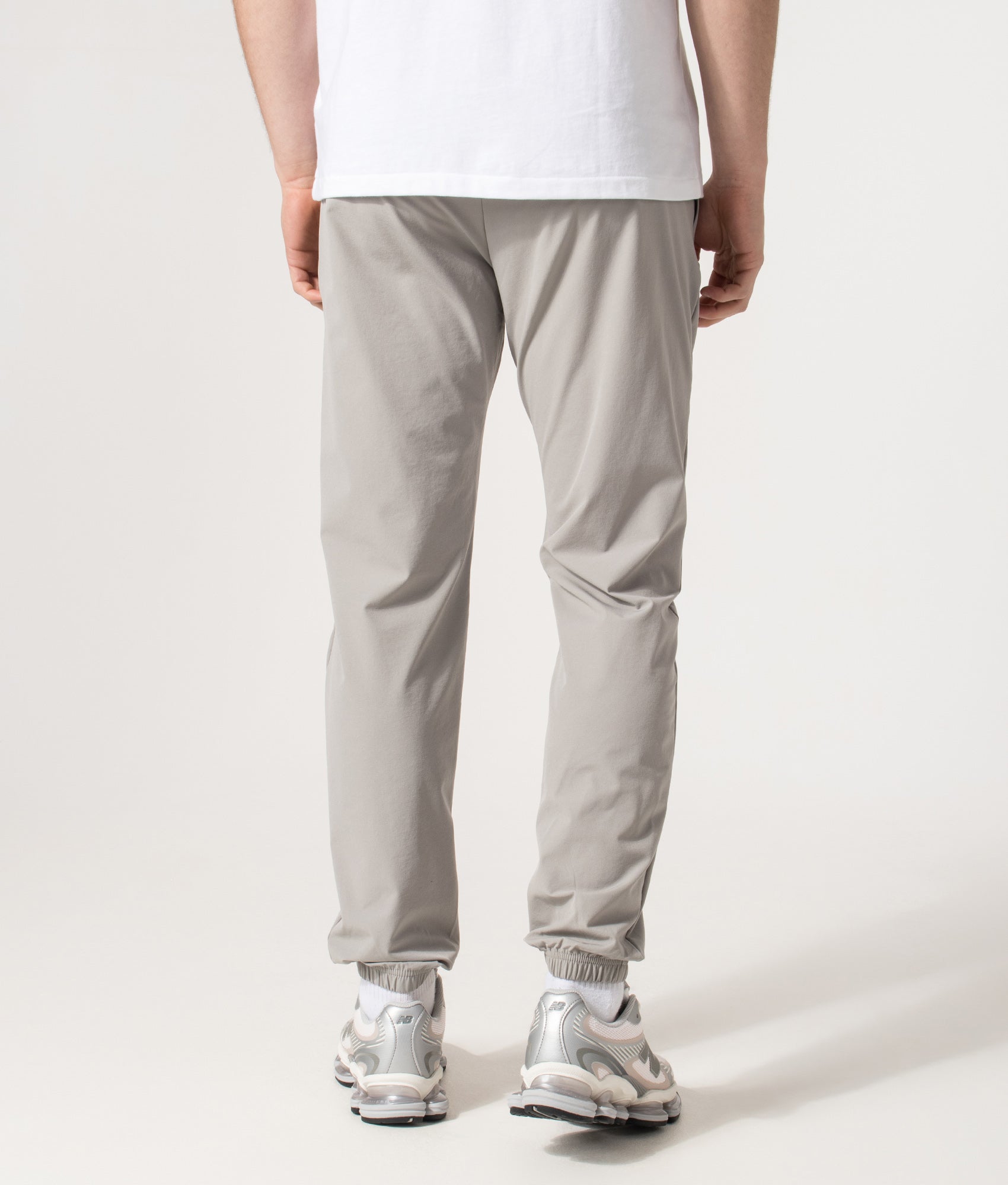 REFLECT Woven Track Pants in Grey at EQVVS Menswear. Model back shot.