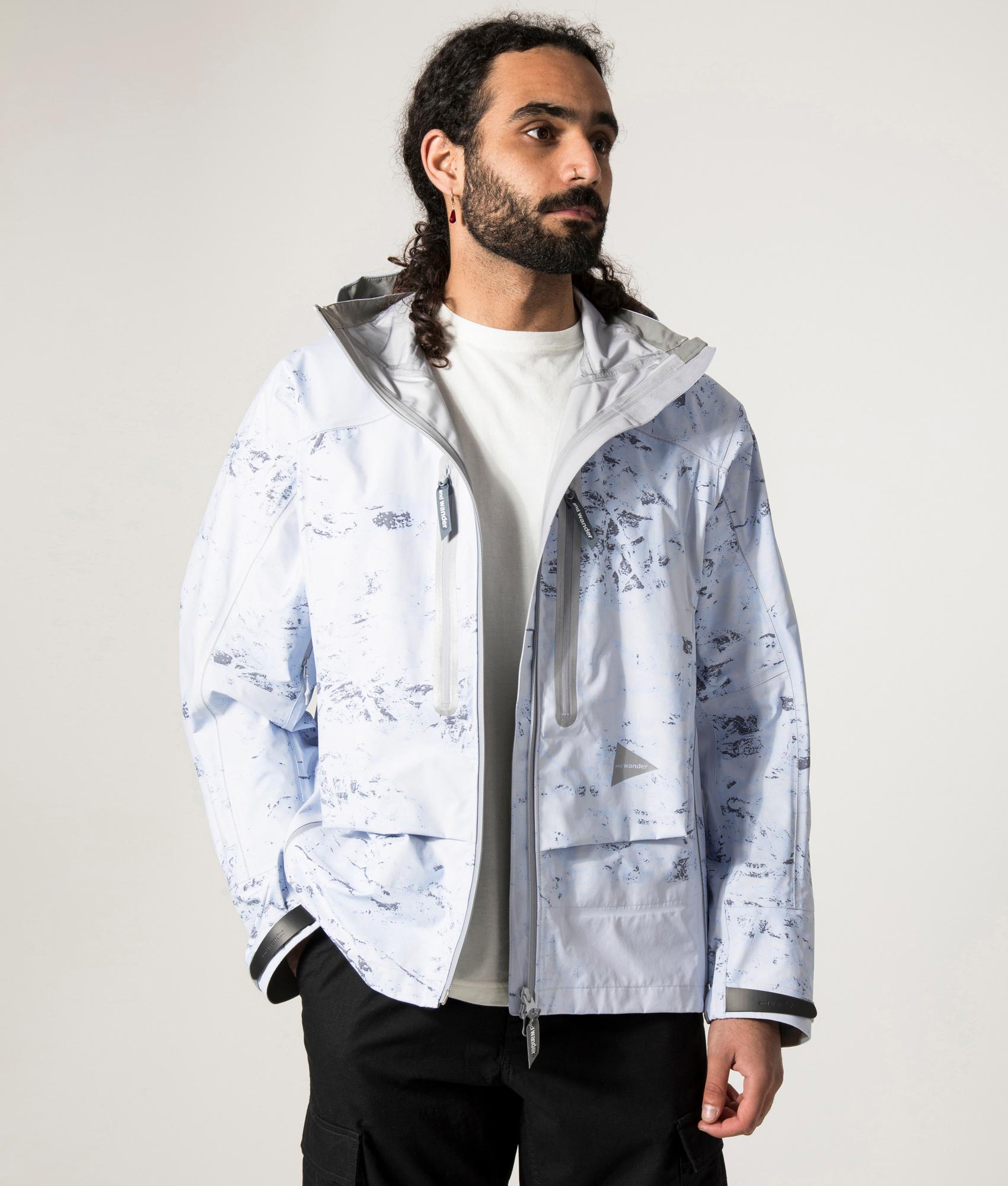 Pertex Shield Rain Jacket in Light Blue by And Wander at EQVVS Menswear. Open Jacket Model Shot. 