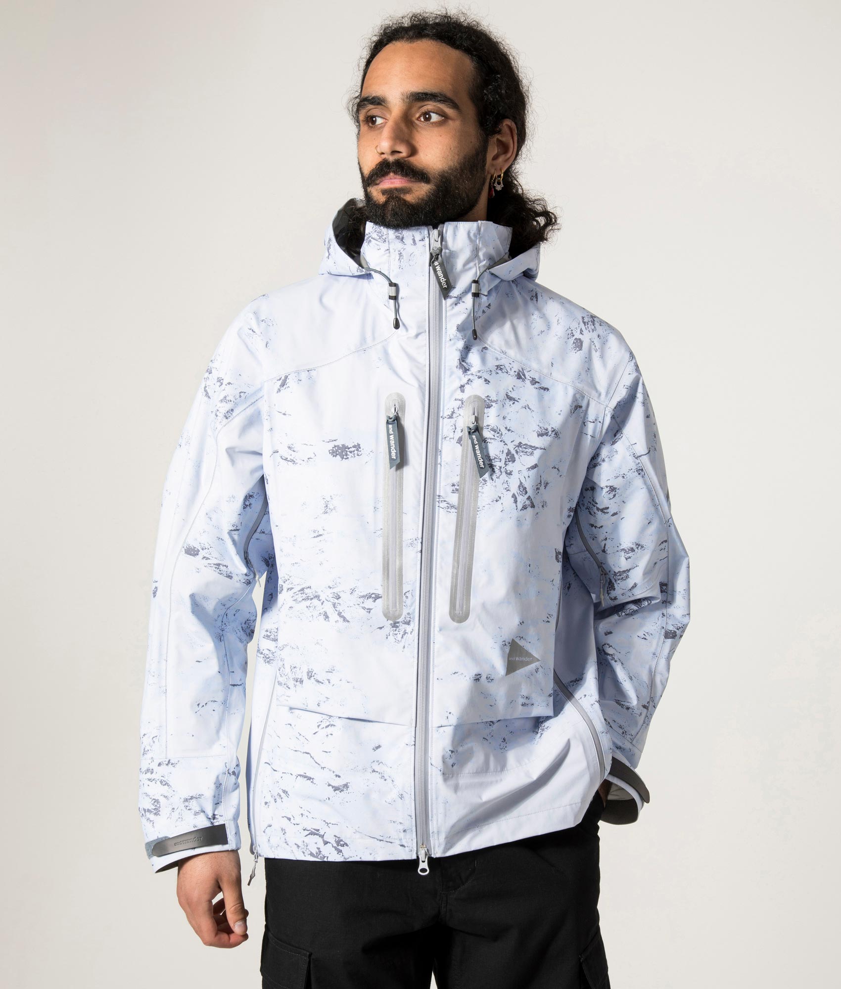Pertex Shield Rain Jacket in Light Blue by And Wander at EQVVS Menswear. Front Model Shot.