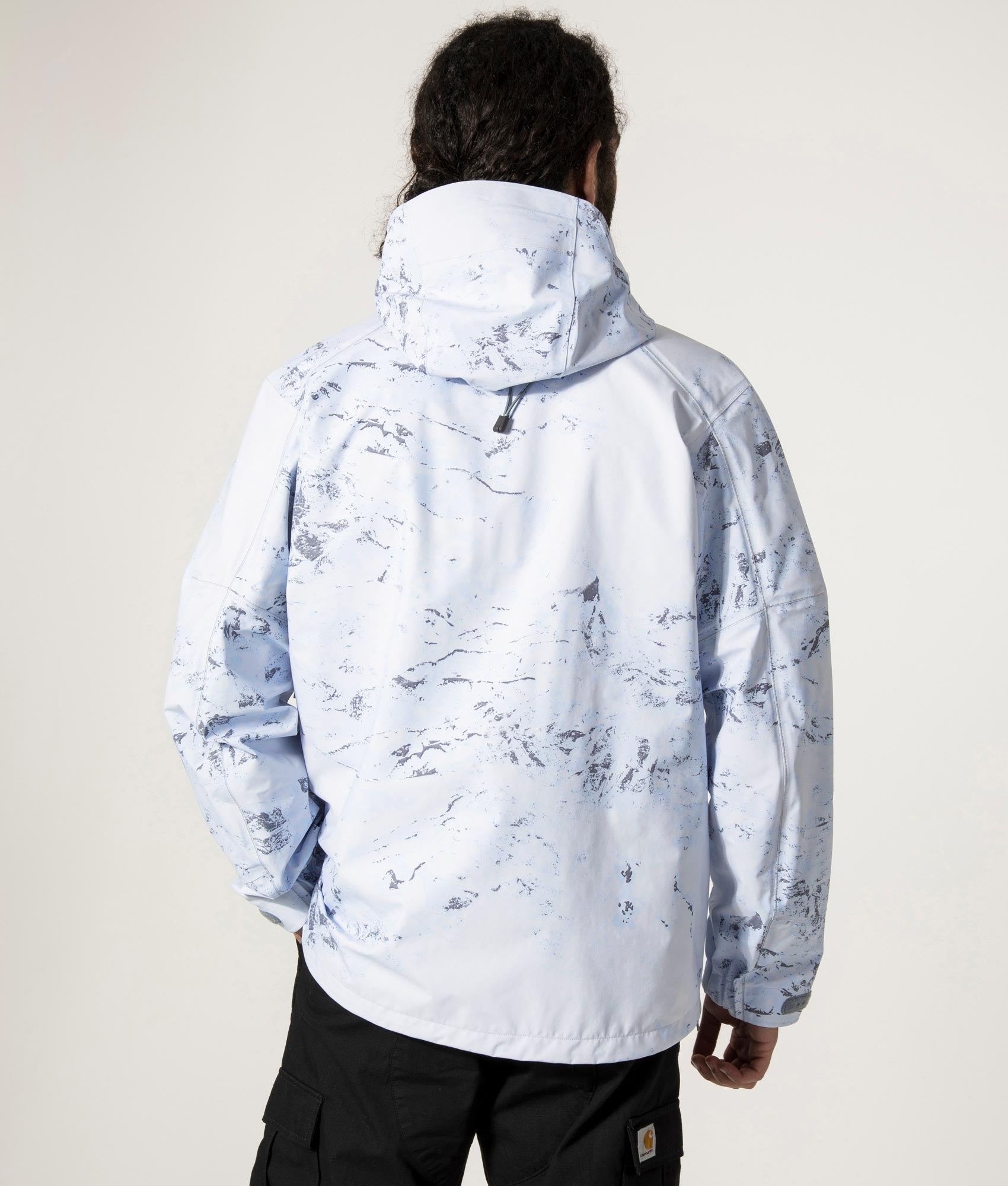 Pertex Shield Rain Jacket in Light Blue by And Wander at EQVVS Menswear. Back Model Shot.