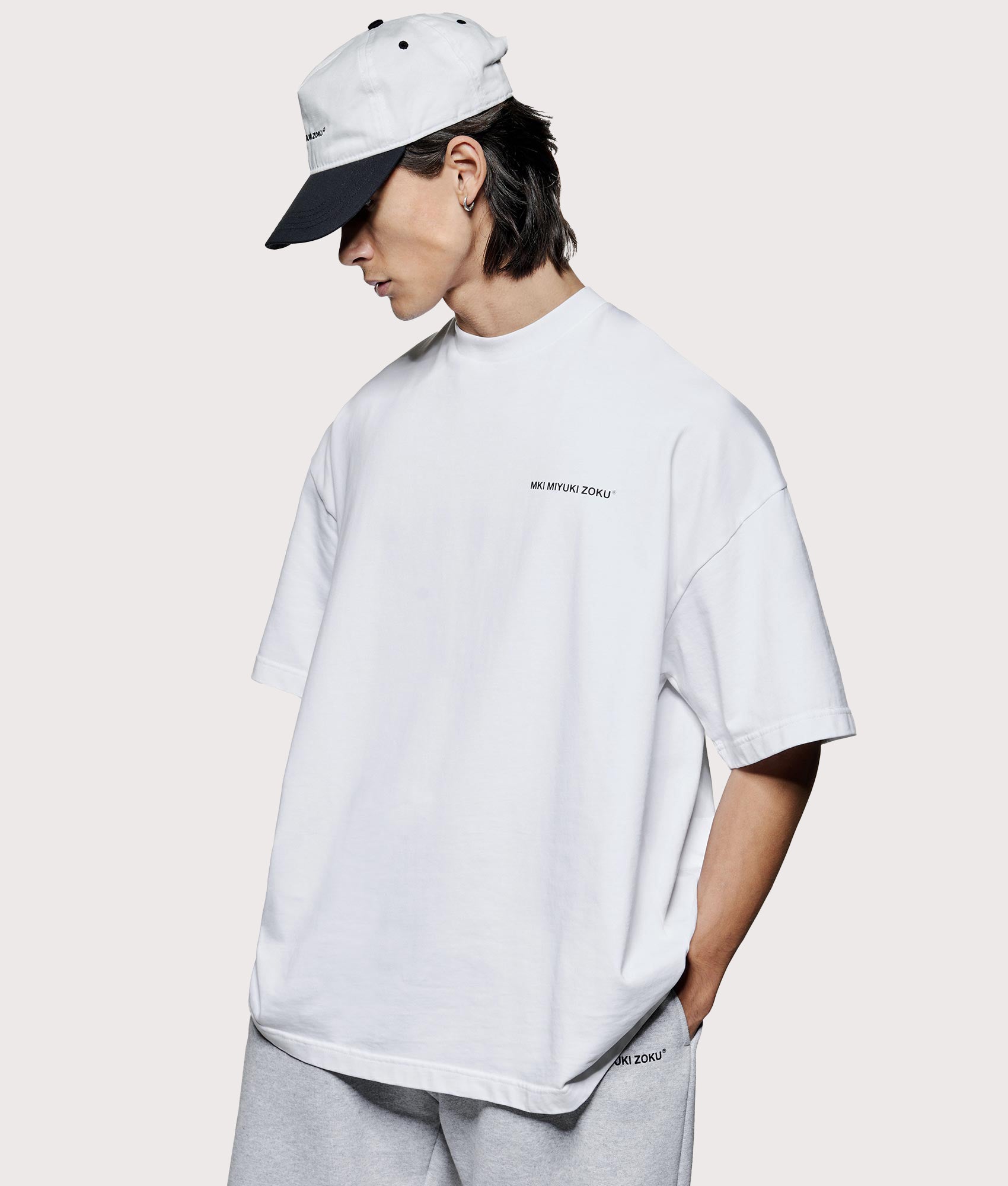 MKI MIYUKI ZOKU Oversized Uniform T-Shirt at EQVVS Menswear. Angled Model shot.