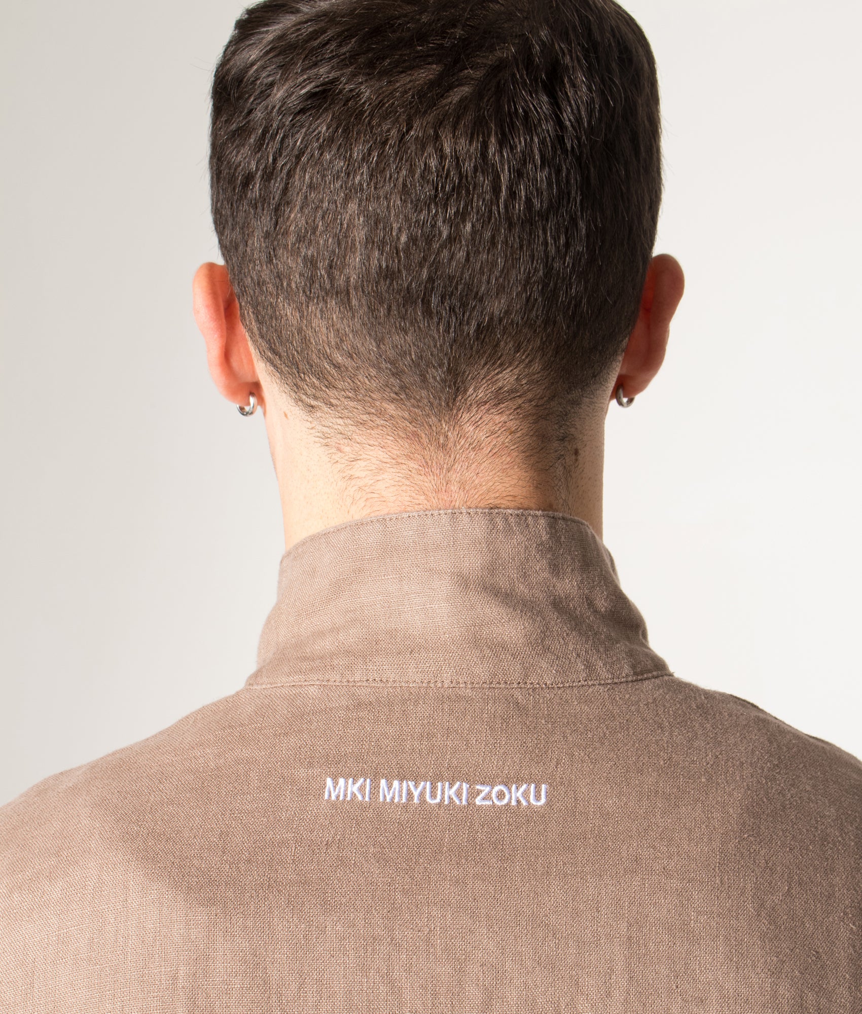 Linen Track Jacket in Mushroom. 100% Linen | MKI MIYUKI ZOKU | Shot at EQVVS | Back detail model shot 
