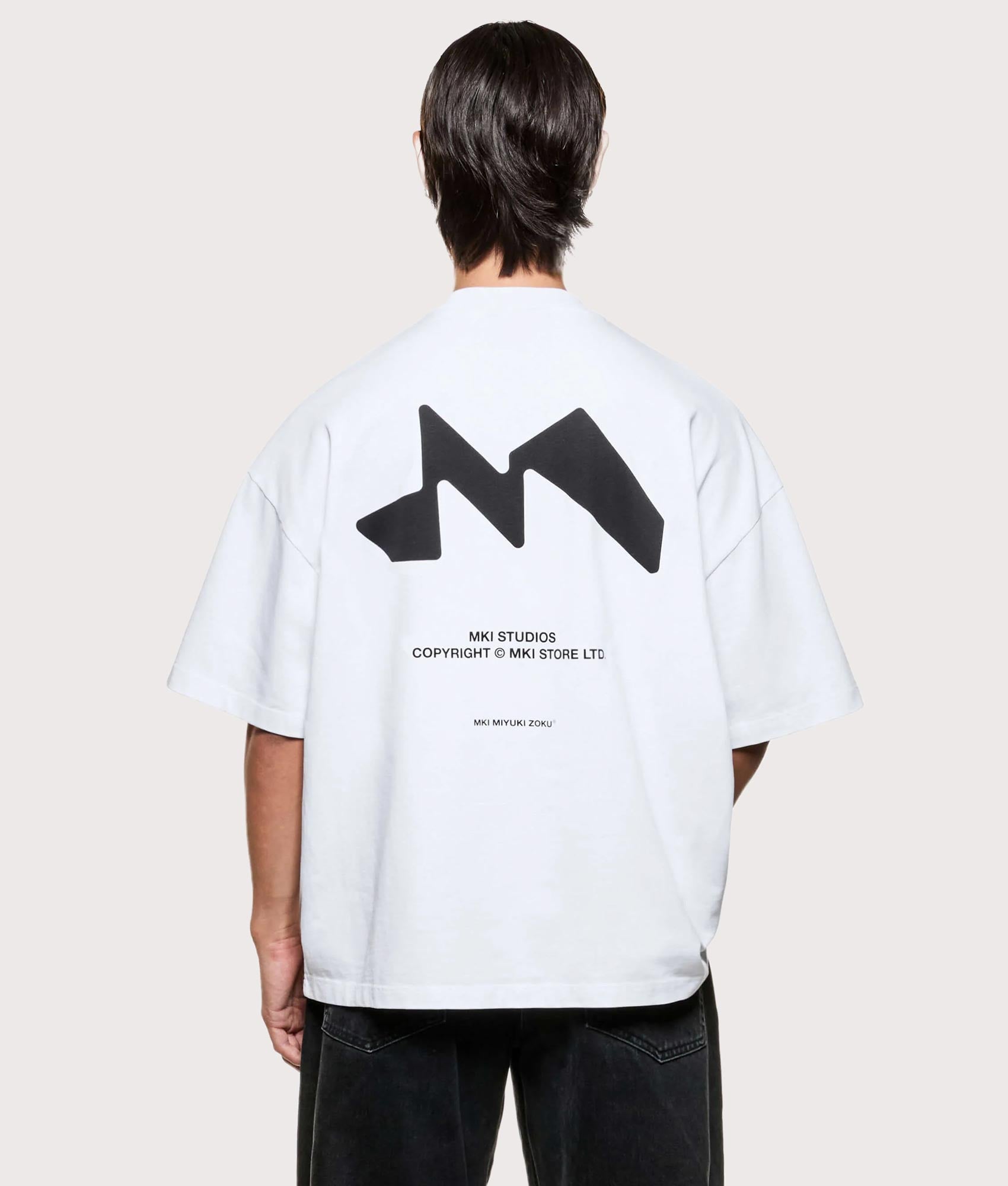 MKI MIYUKI ZOKU Silhouette T-Shirt in White at EQVVS Menswear. Model back shot.