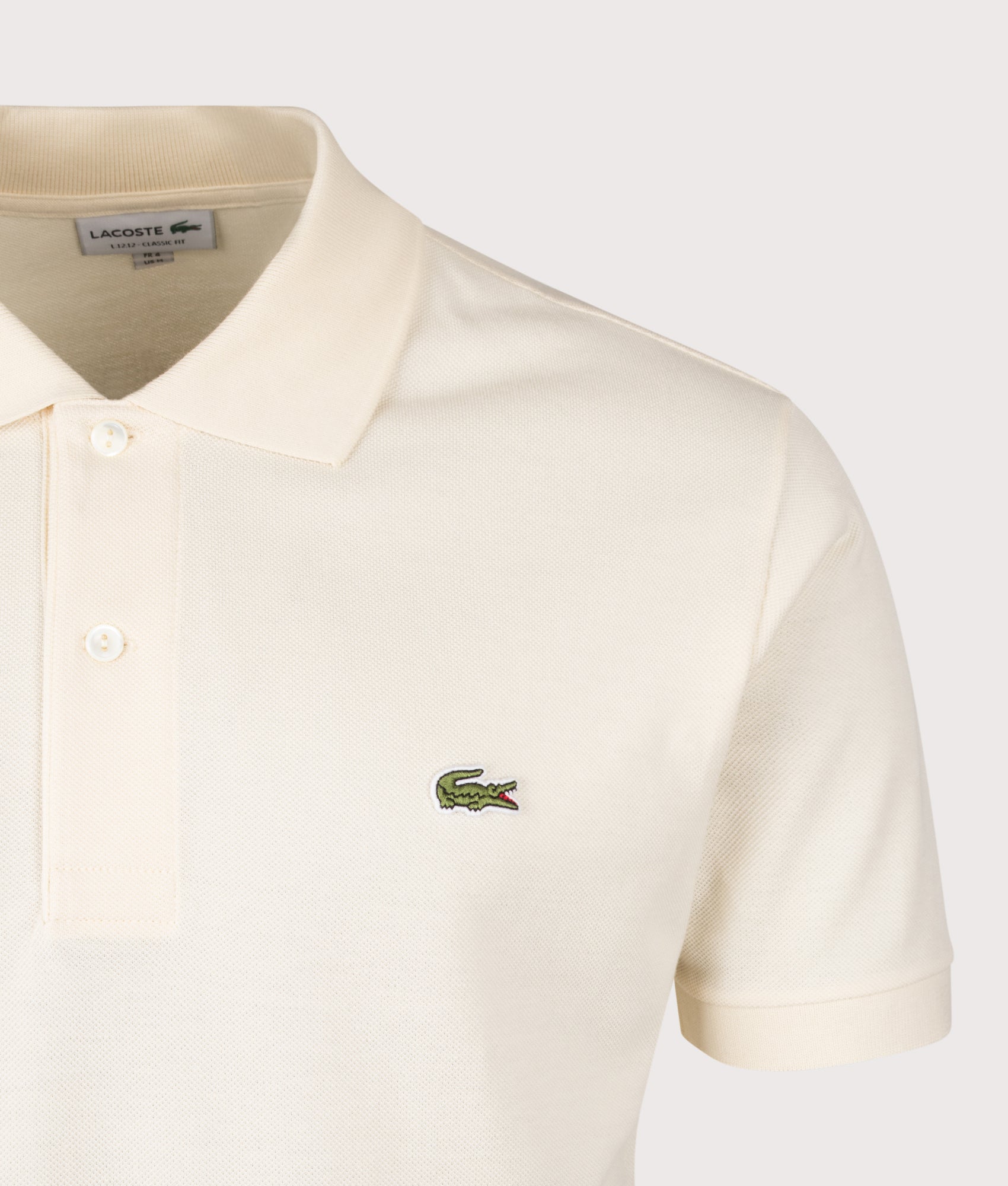 Lacoste Classic Fit L1212 Croc Logo Polo Shirt in Natural Clair at EQVVS Menswear. Detail shot.