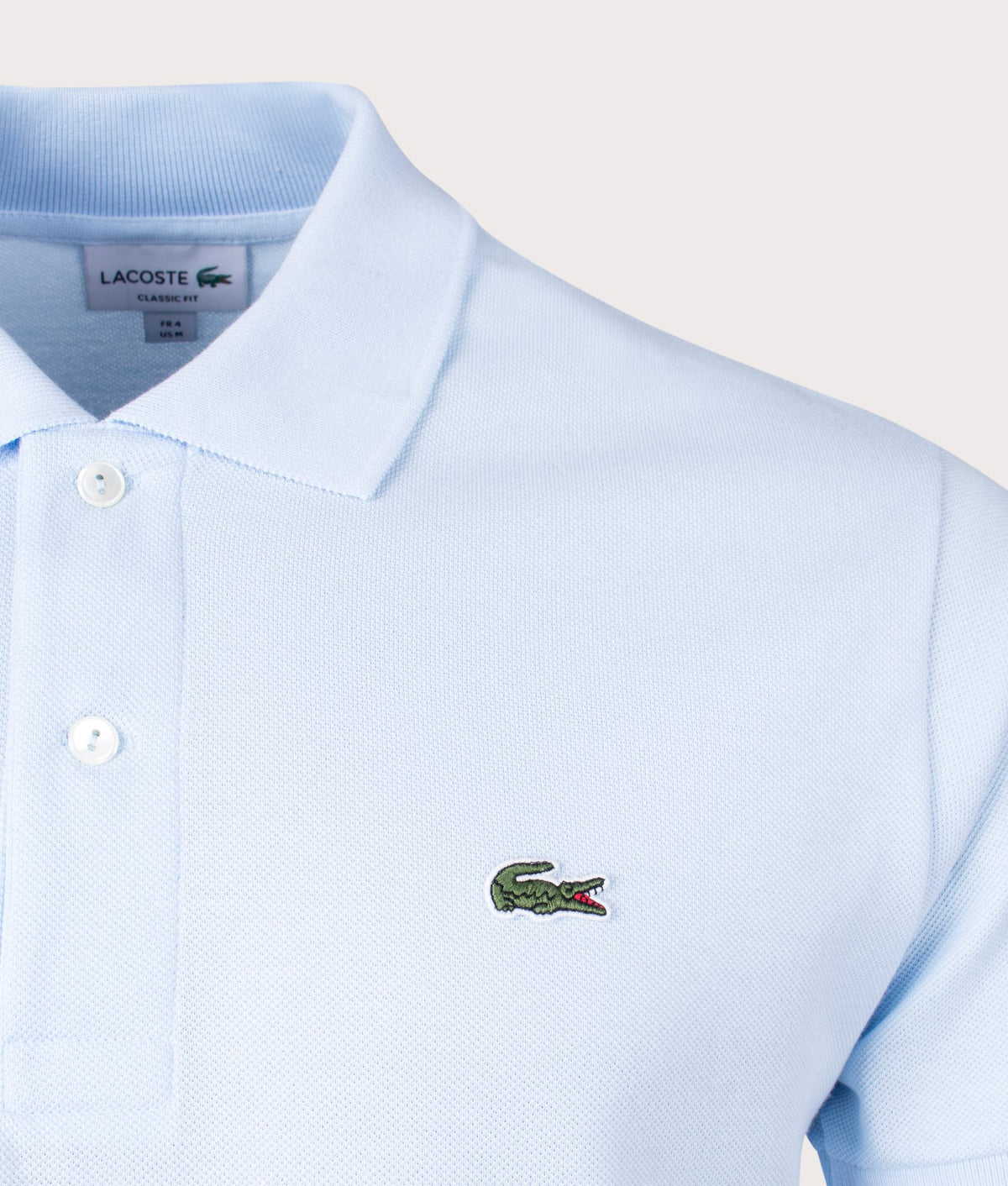 Lacoste Croc Logo L1212 Polo Shirt in Light Blue at EQVVS Menswear. Detail shot.