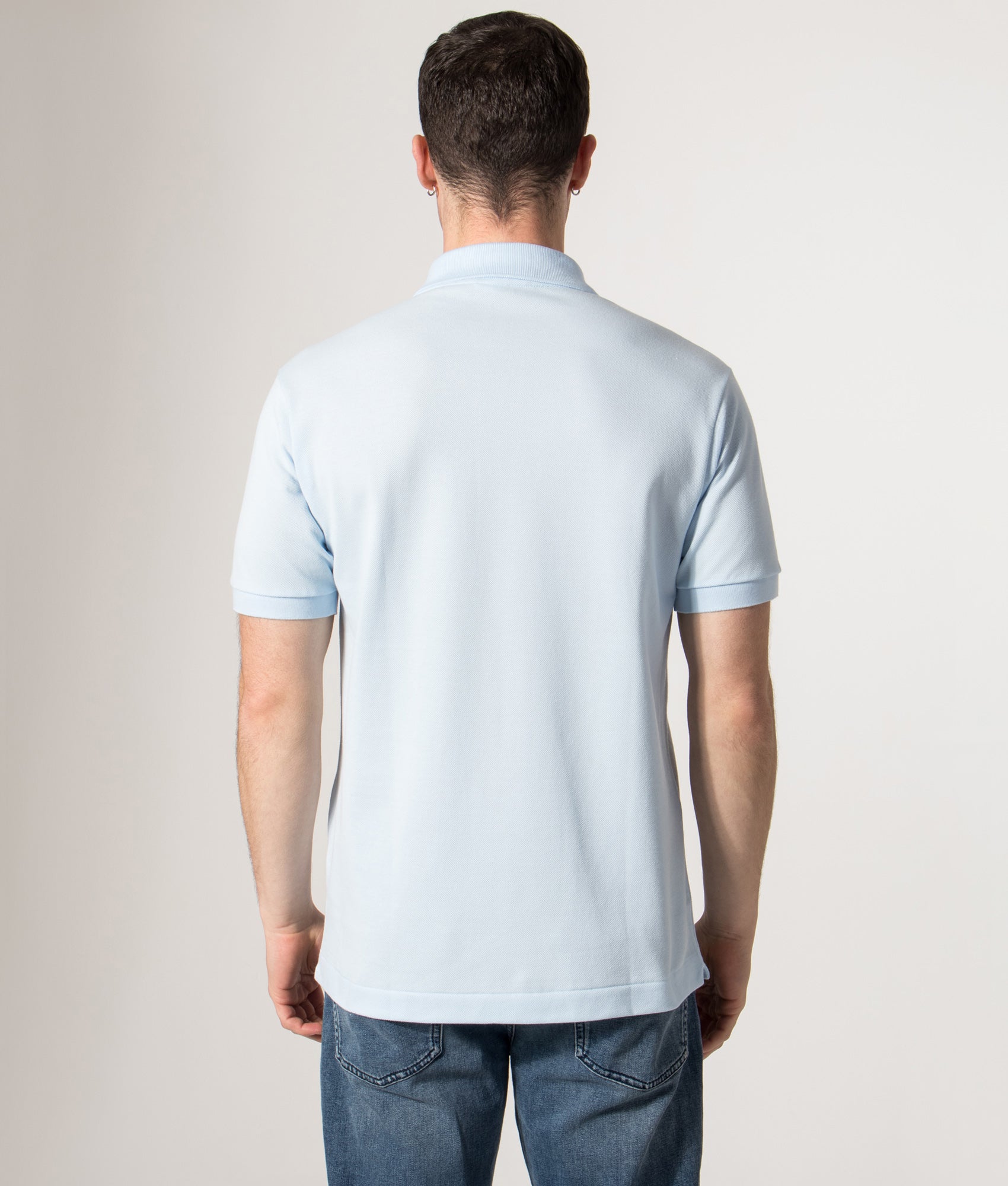 Lacoste Croc Logo L1212 Polo Shirt in Light Blue at EQVVS Menswear. Model back shot.
