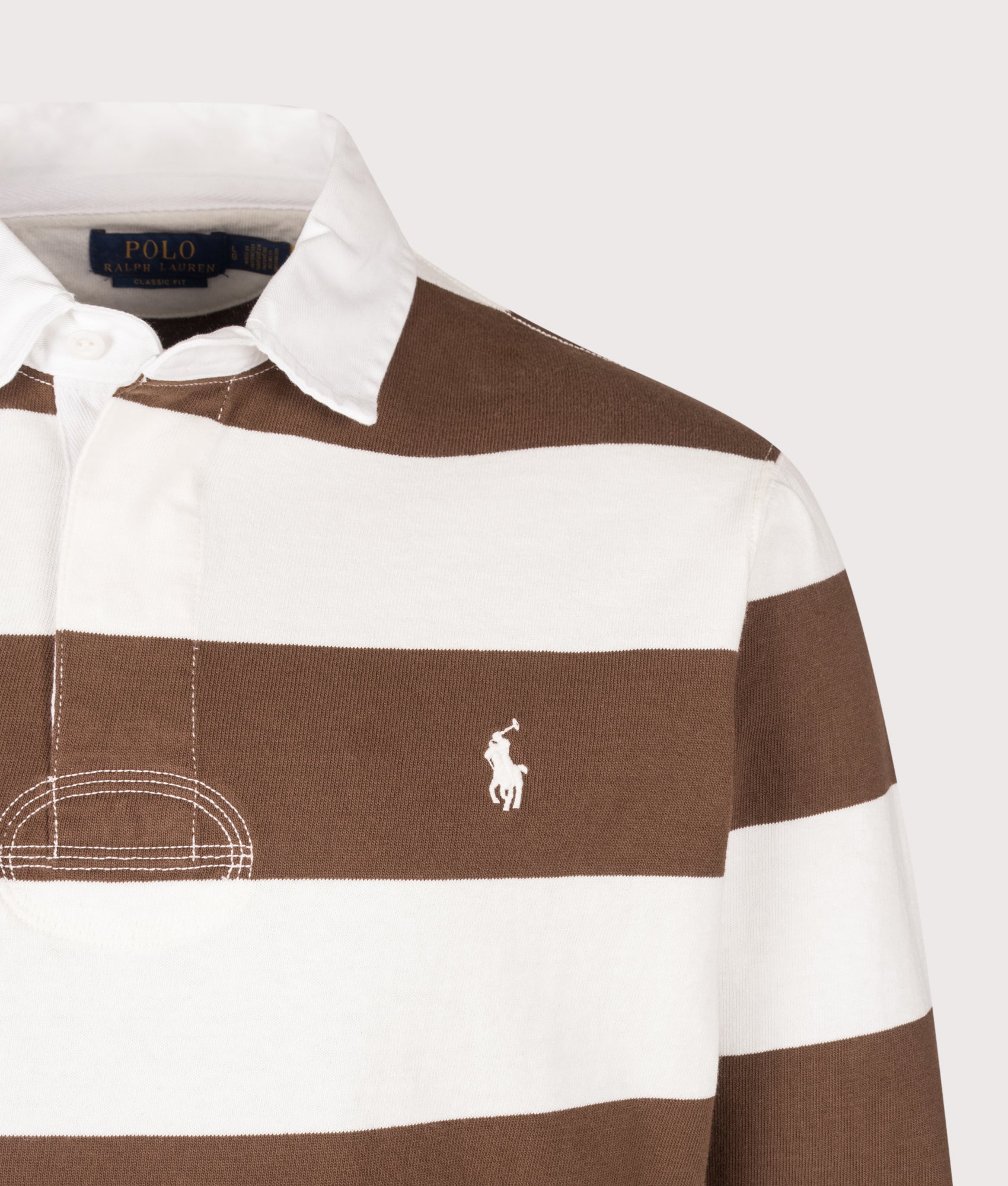 Polo Ralph Lauren Classic Fit The Iconic Striped Rugby Shirt in Trophy Cream and Chocolate Brown at EQVVS Menswear. Detail shot.