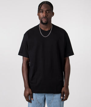 CDG Script Hem Logo T-Shirt in Black. Front angle shot at EQVVS.