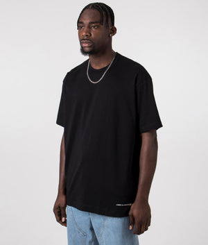 CDG Script Hem Logo T-Shirt in Black. Front side angle shot at EQVVS.