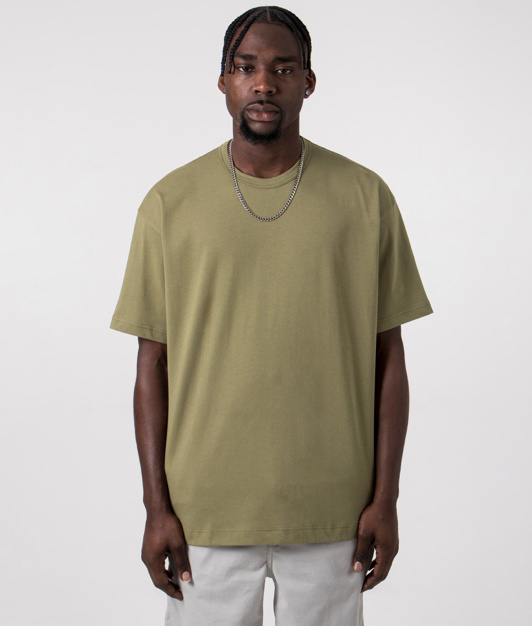 CDG Script Hem Logo T-Shirt in Khaki. Front angle shot at EQVVS.