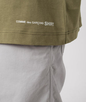 CDG Script Hem Logo T-Shirt in Khaki. Detail shot at EQVVS.